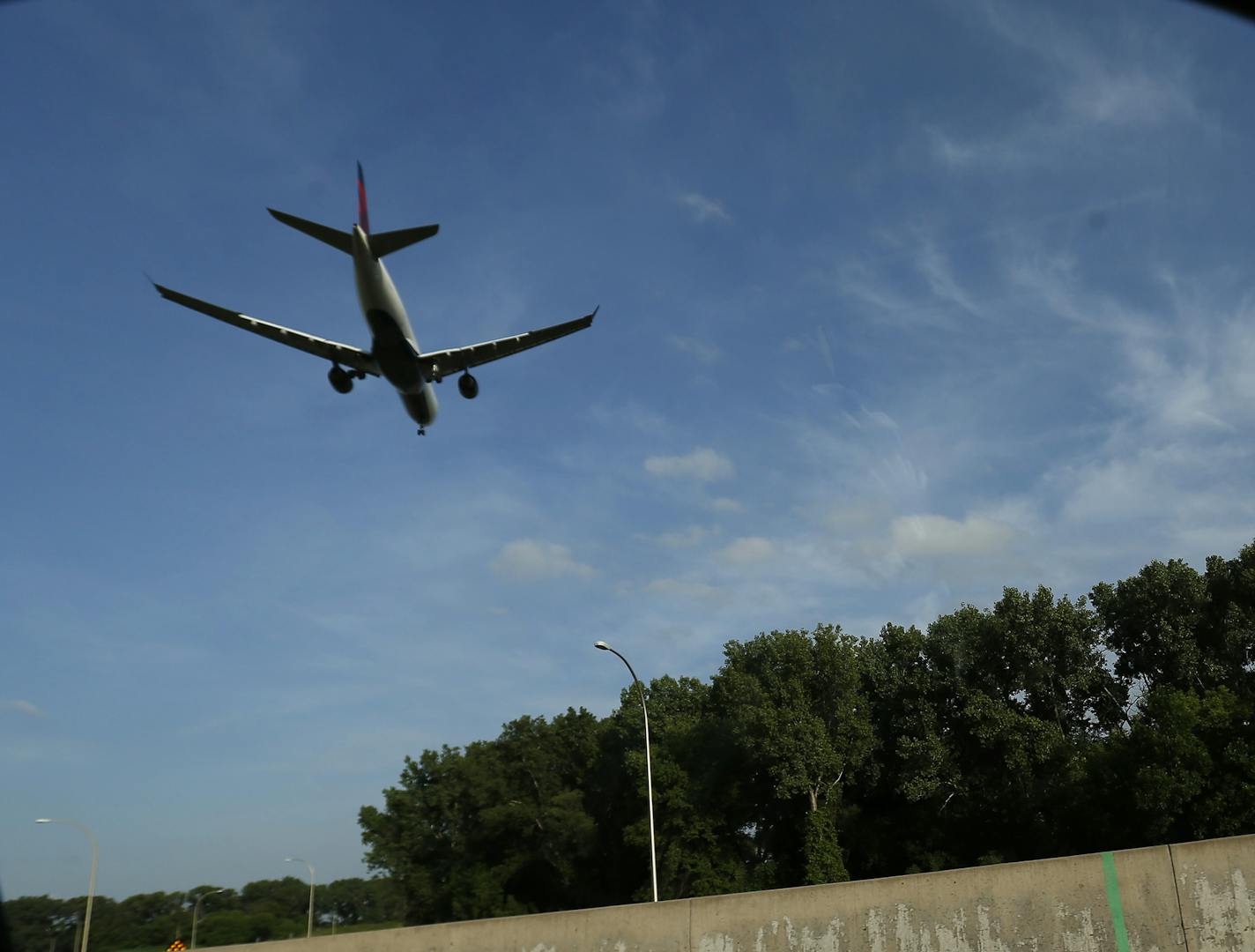 A plane crosses Highway 62 as it prepared to land at Minneapolis St. Paul International Airport.