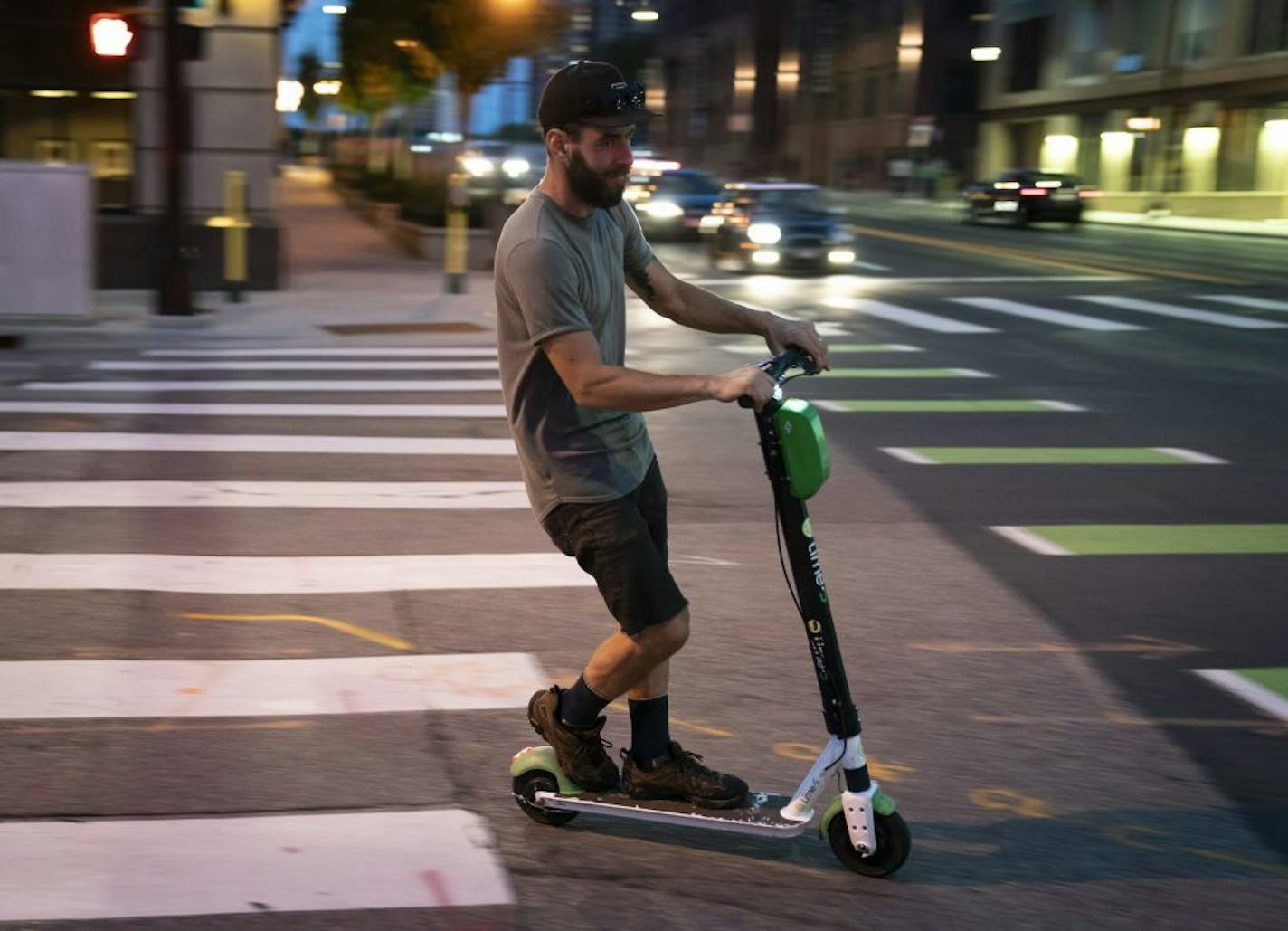 Andy Emerson rode a Lime scooter he collected from downtown Minneapolis on Thursday, Aug. 1, to bring home and charge up for continued use. New signs have popped up recently in Minneapolis reminding users it's illegal to ride on sidewalks.