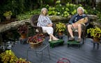 Christine Scotillo and Doug Peine, with their dog Gracie, relax on a round deck built in the middle of their back-yard pond. Their St. Paul garden is 