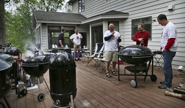 Nine smokers with various meats are smoked on Joe Pupel's deck as he, center, and several other smoking aficianado's gather during Smokapalooza 2013, 