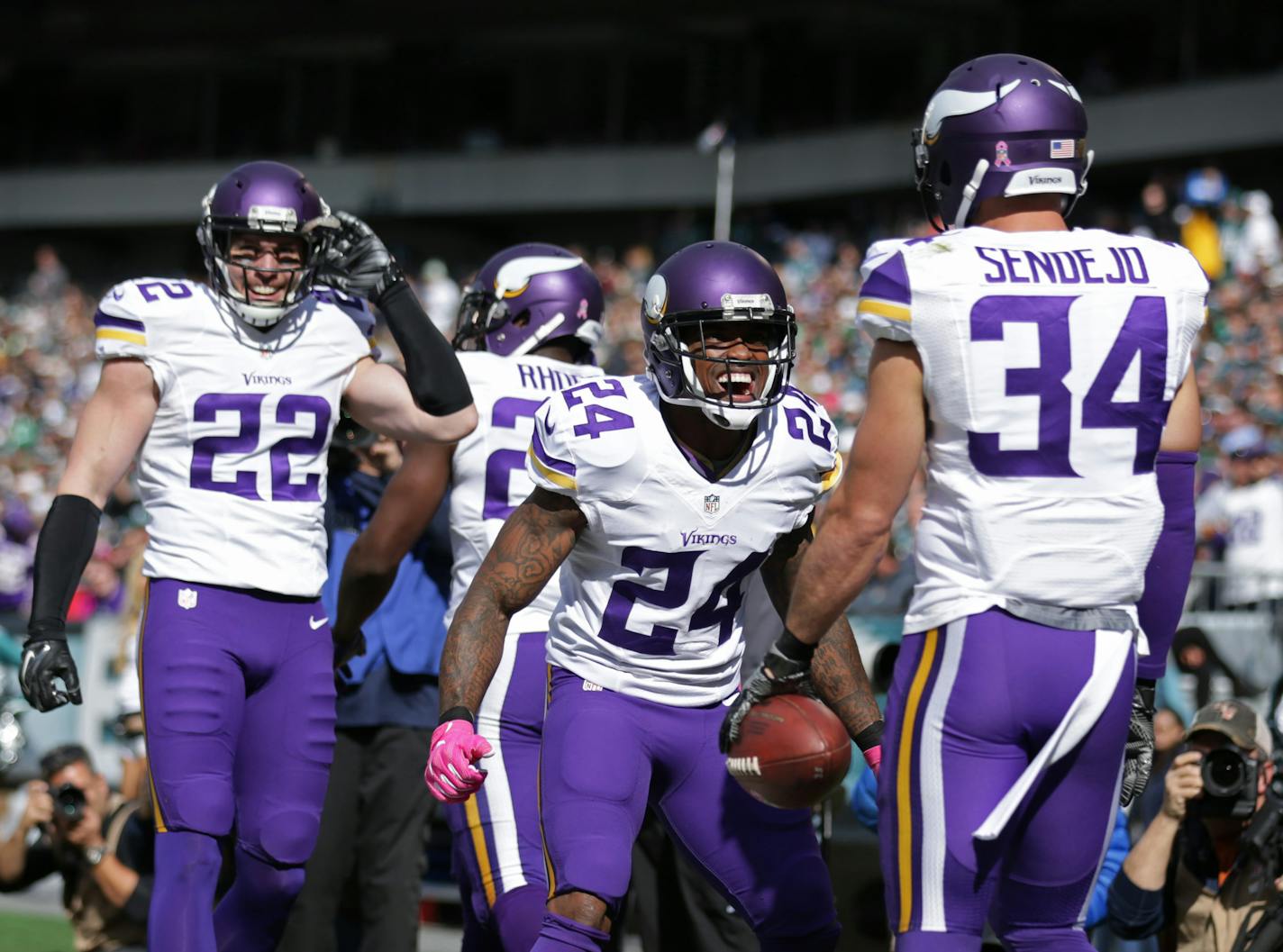 Vikings cornerback Captain Munnerlyn (24) celebrated an interception by teammate Andrew Sendejo (34) in the first quarter against the Eagles on Sunday.