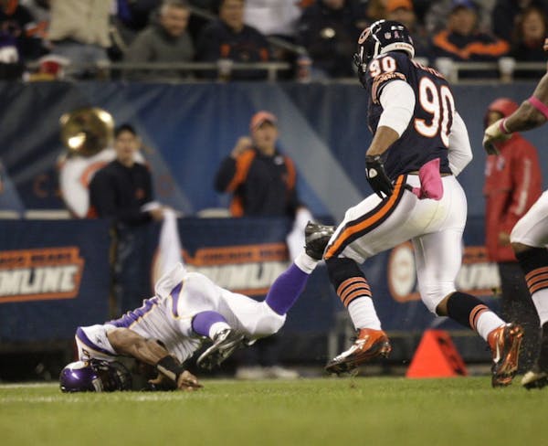 Vikings quarterback Donovan McNabb hits the turf hard after being pushed by Julius Peppers in the 4th quarter.