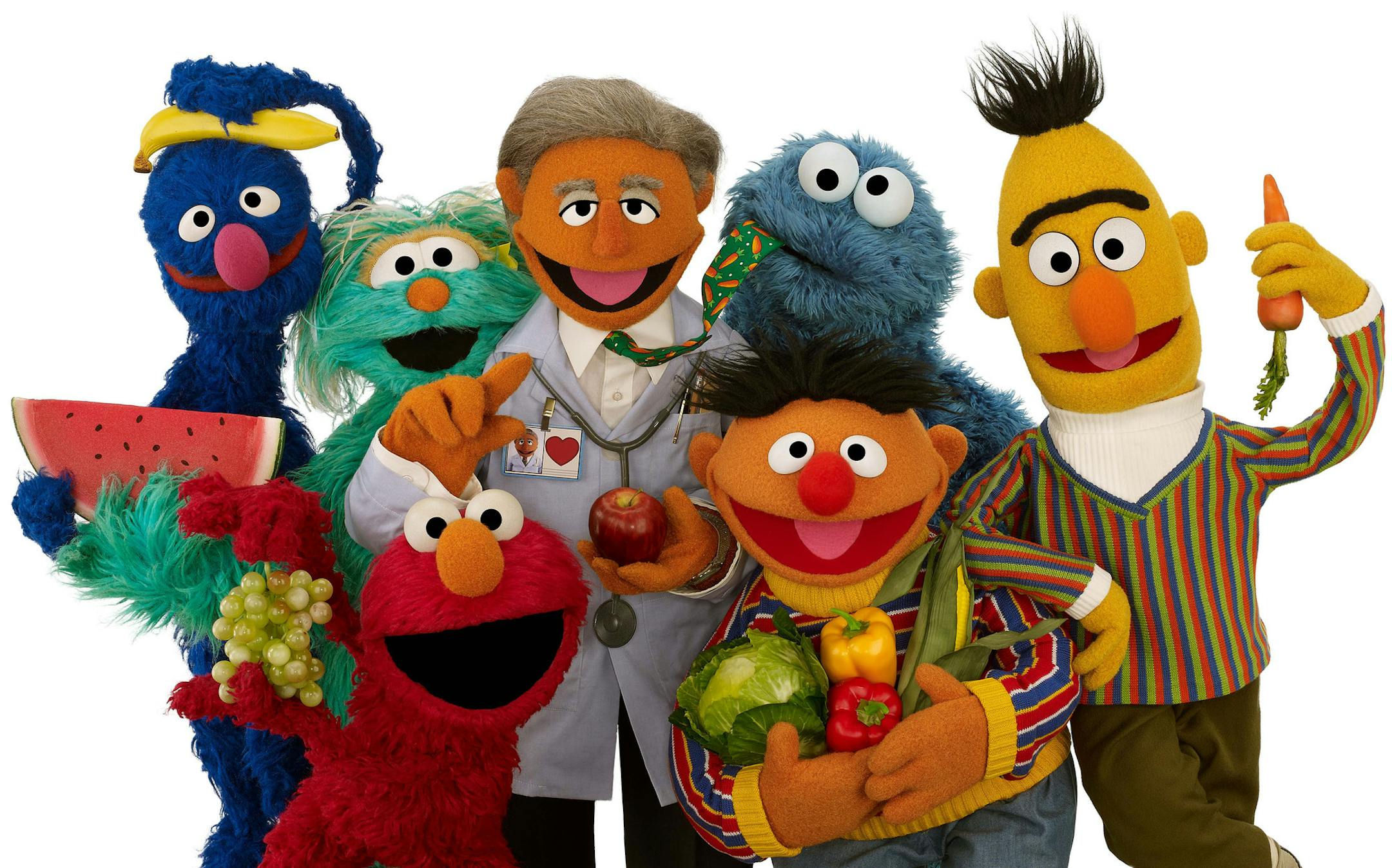 New Muppet Dr. Ruster, center, with, from left, Grover, Rosita, Elmo, Cookie Monster, Ernie and Bert. Dr. Valentin Fuster, a cardiologist at New York's Mount Sinai Hospital who Dr. Ruster is based on, teamed up with Sesame Street on a project to improve kids' health, and it has shown progress in a study in Colombia. In 2014, the project is planned to launch in New York in what sponsors hope will be a first step to fight childhood obesity nationwide.