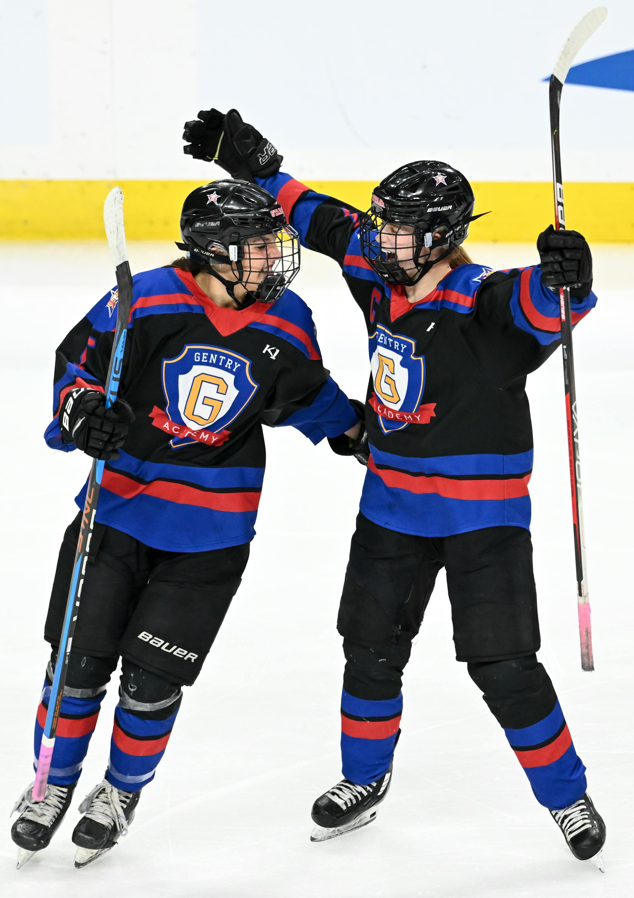 Gentry forward Alexa Hanrahan (5) and forward Cara Sajevic (7) celebrate the game-tying score by Hanrahan against the Minnetonka Skippers during the third period.
