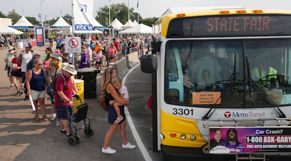 Fairgoers waited in long lines Tuesday to board buses at the Minnesota State Fair’s Transportation Hub in Falcon Heights.