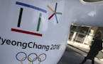 The official emblem of the 2018 Pyeongchang Games is seen in downtown Seoul, South Korea, Thursday, Feb. 1, 2018. In a rare sight, North Korean flags 