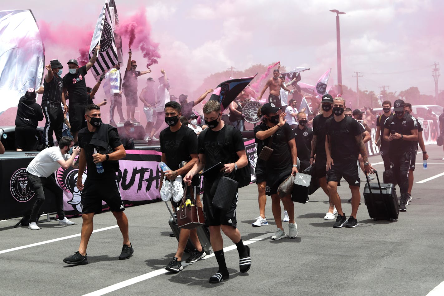 Inter Miami CF soccer players are greeted by fans as they leave their stadium in Fort Lauderdale, Fla. for a Major League Soccer tournament in Orlando, Wednesday, July 1, 2020. All 26 Major League Soccer teams will compete in a tournament in Orlando beginning July 8, as the league returns to play during the new coronavirus pandemic. (AP Photo/Lynne Sladky)