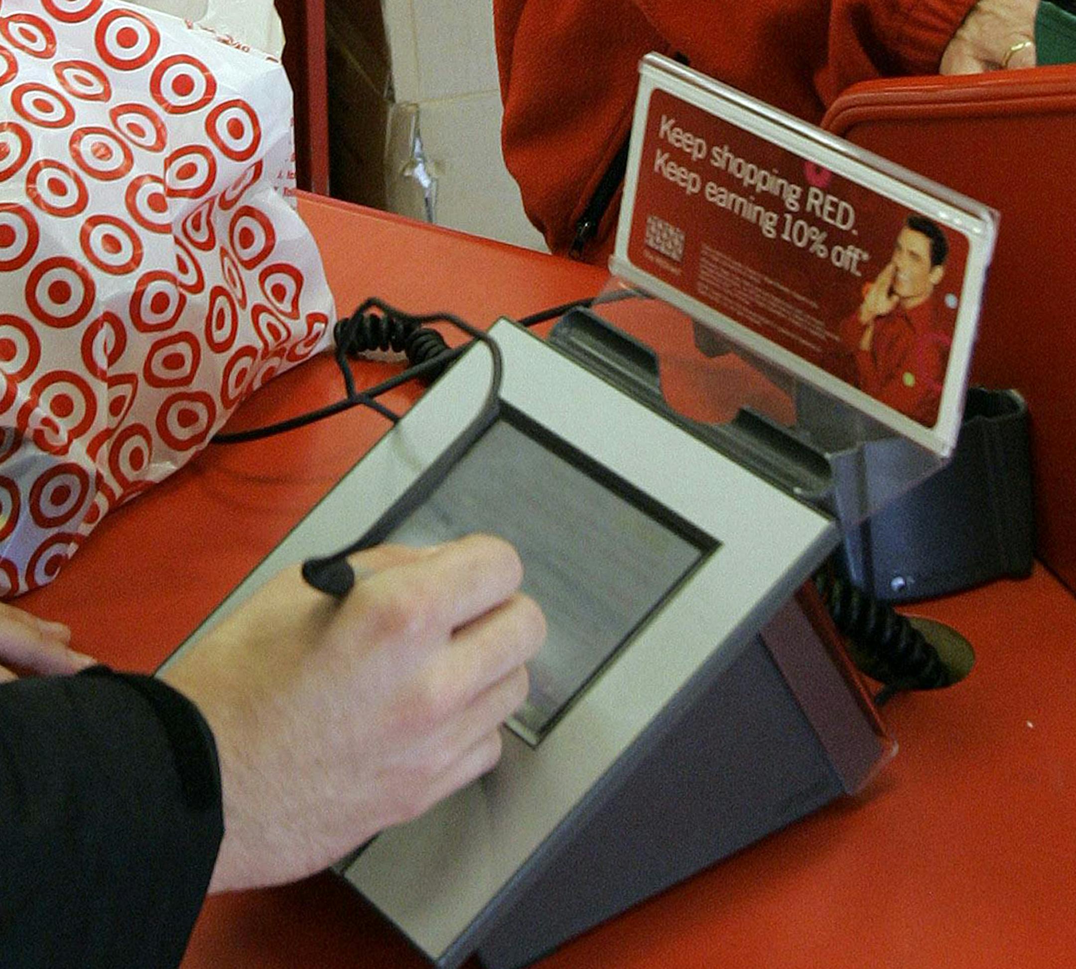 FILE - In this Jan. 18, 2008 file photo, a customer signs his credit card receipt at a Target store in Tallahassee, Fla.