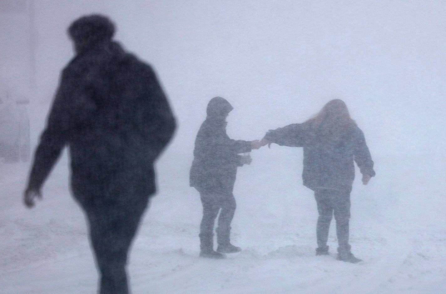 People in Anoka walked through the whiteout conditions as the storm arrived Wednesday morning in the Twin Cities.