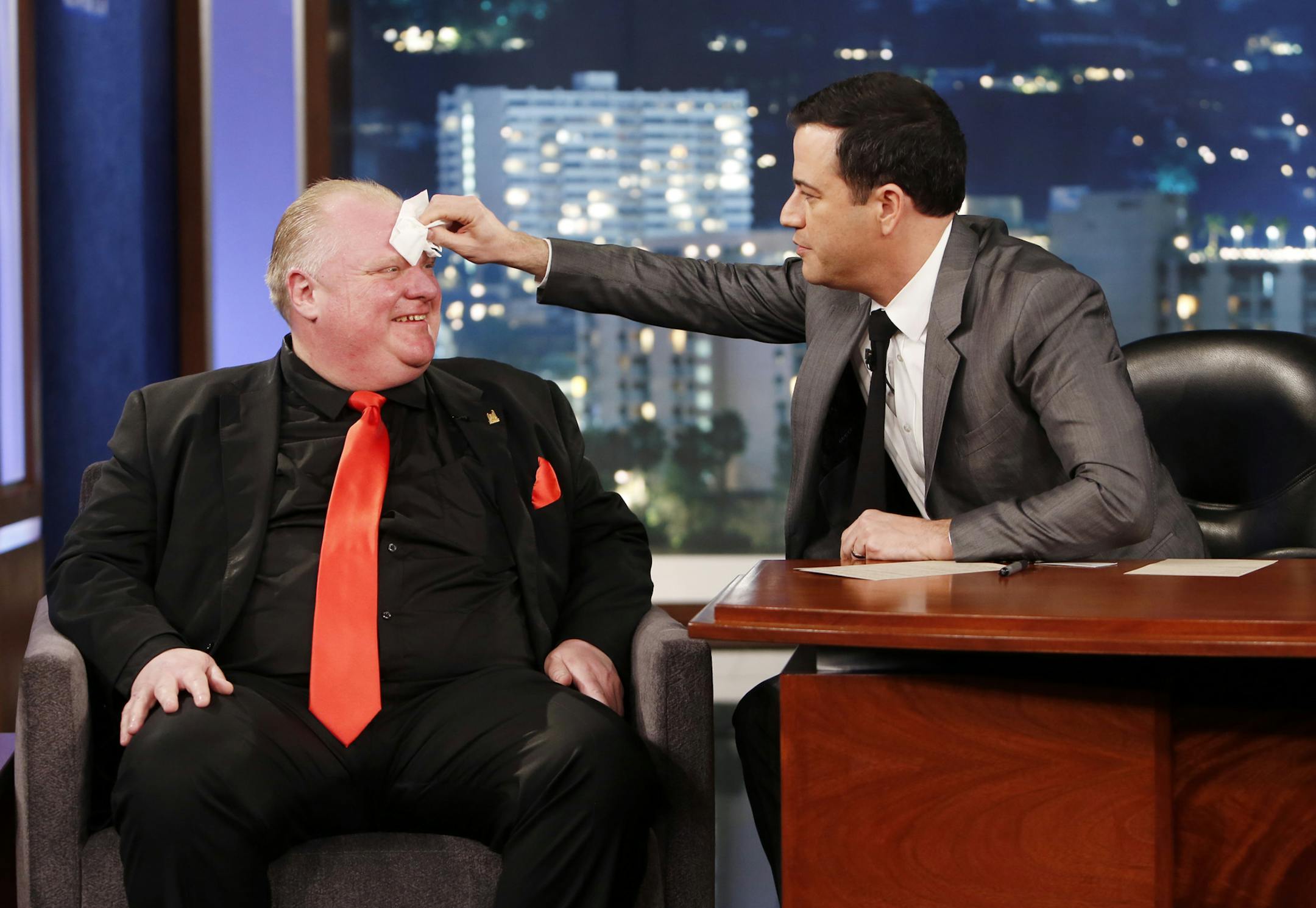This March 3, 2014 image released by ABC shows Toronto Mayor Rob Ford, left, having his forehead wiped by host Jimmy Kimmel on the late night talk show "Jimmy Kimmel Live," in Los Angeles. Ford laughed off Jimmy Kimmel's suggestion that he get help for his drinking problem and was reported to be upset about his appearance on the late-night TV talk show. Ford's appearance Monday night on "Jimmy Kimmel Live" in Los Angeles was the culmination of months of wooing by the talk-show host to get Ford t