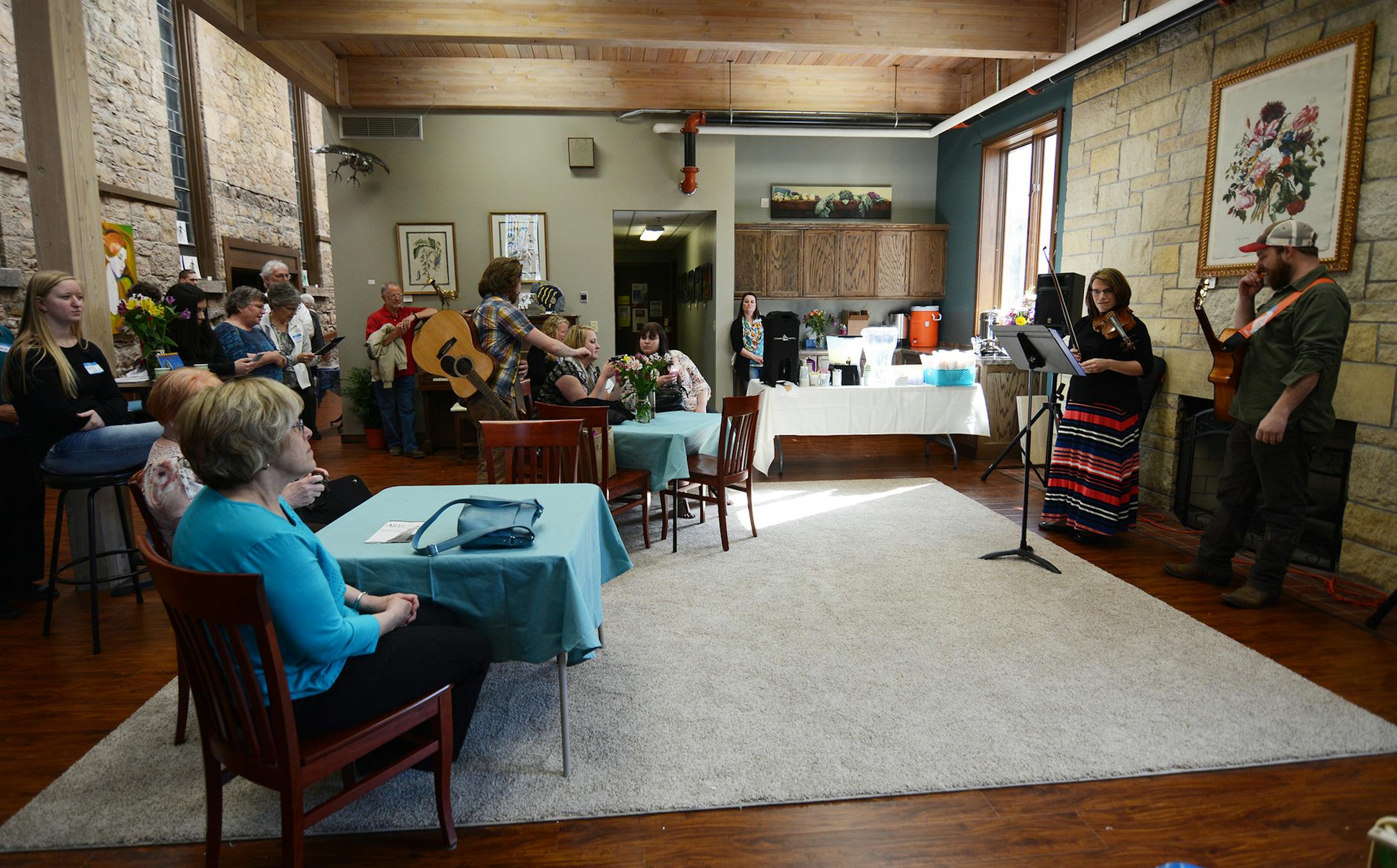 Hastings Arts Center founder Sarah Lockwood and Andrew Gathright, of Hastings, performed a mini concert in the atrium of the newly renovated facility. Photo by Liz Rolfsmeier, Special to the Star Tribune