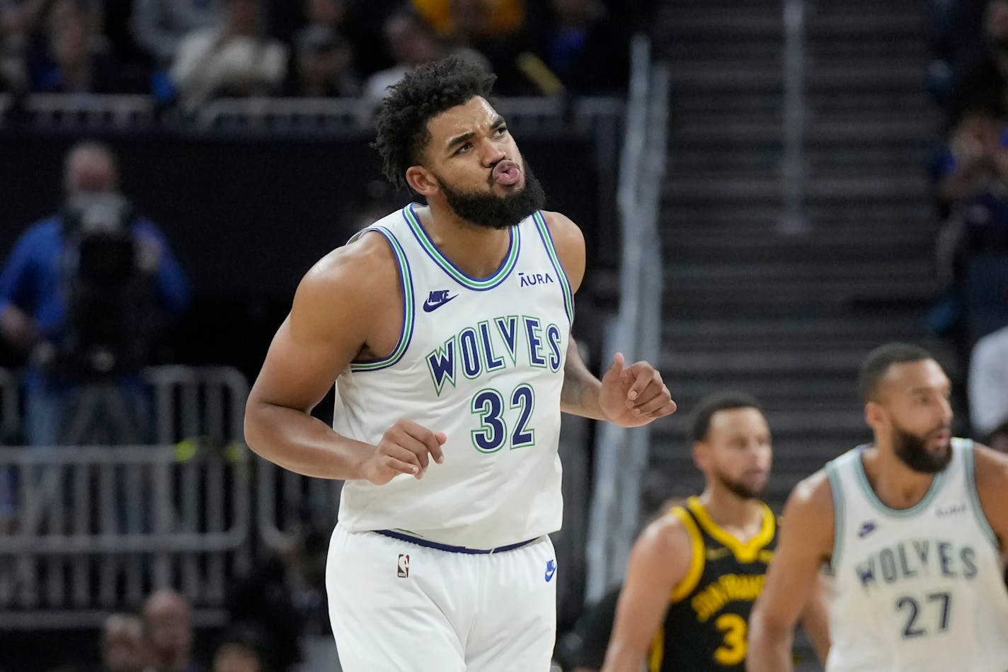 Minnesota Timberwolves center Karl-Anthony Towns (32) reacts after scoring against the Golden State Warriors during the second half of an NBA basketball game in San Francisco, Sunday, Nov. 12, 2023. (AP Photo/Jeff Chiu)