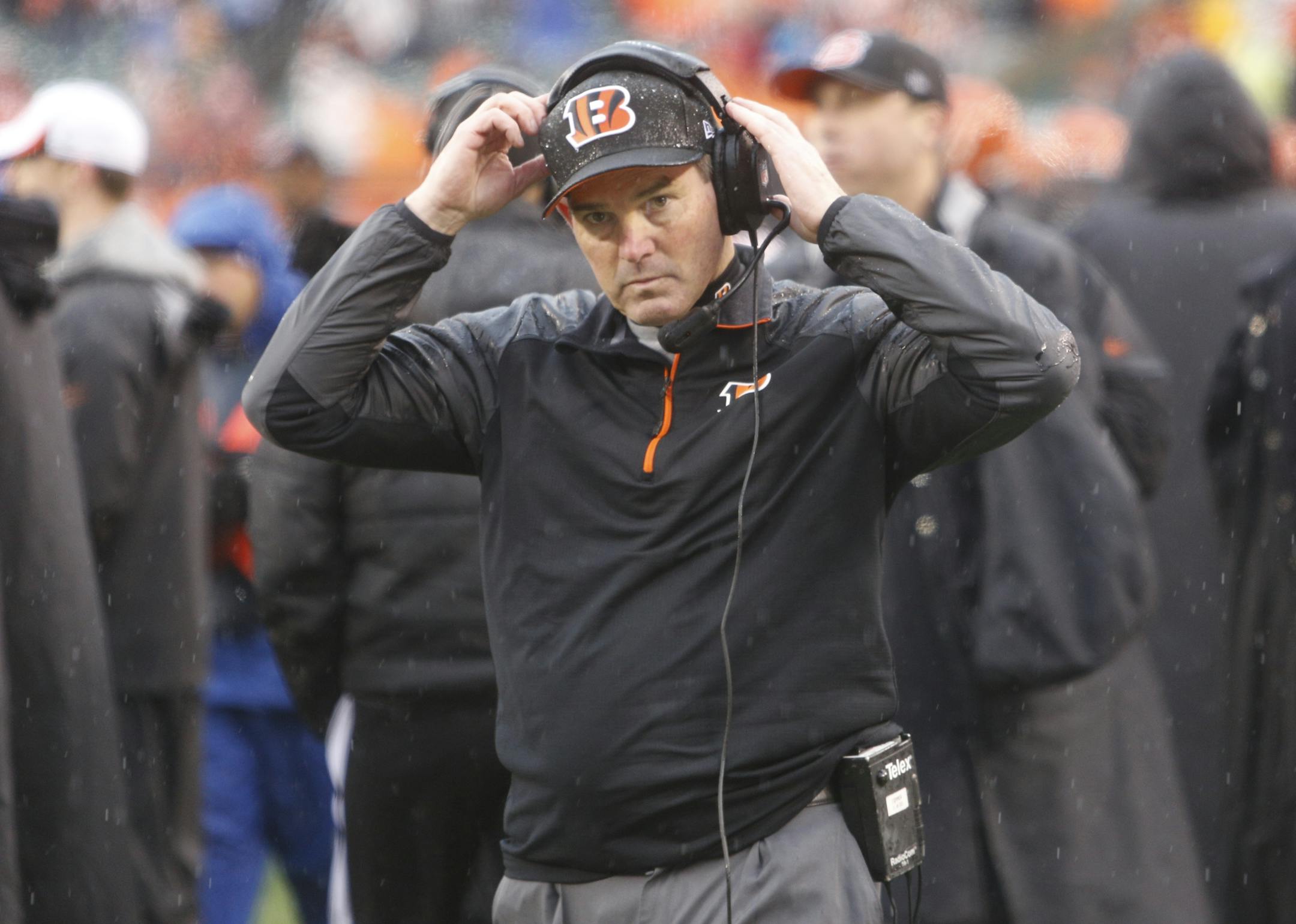 Cincinnati Bengals defensive coordinator Mike Zimmer adjusts his head set in the second half of an NFL wild-card playoff football game against the San Diego Chargers Sunday, Jan. 5, 2014, in Cincinnati.
