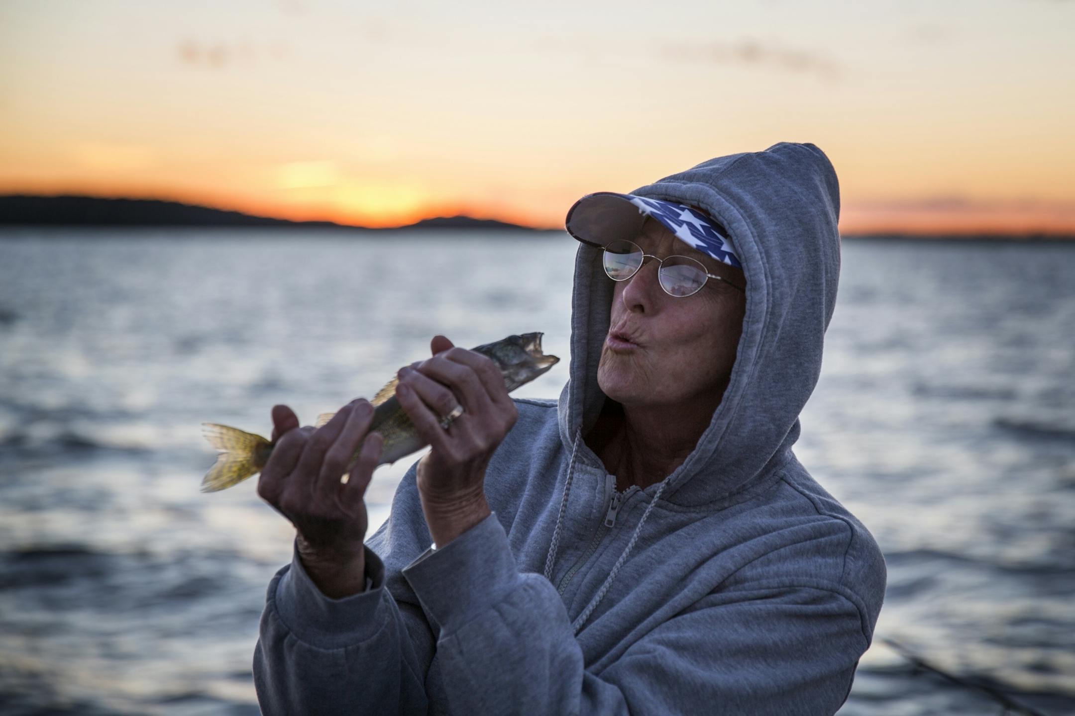 Frankie Giarrusso, East Bethel during the summer and Texas during the winter, pretends to kiss her walleye catch during a fishing expedition with Twin Pines Resort on Mille Lacs Lake Monday, August 3, 2015.