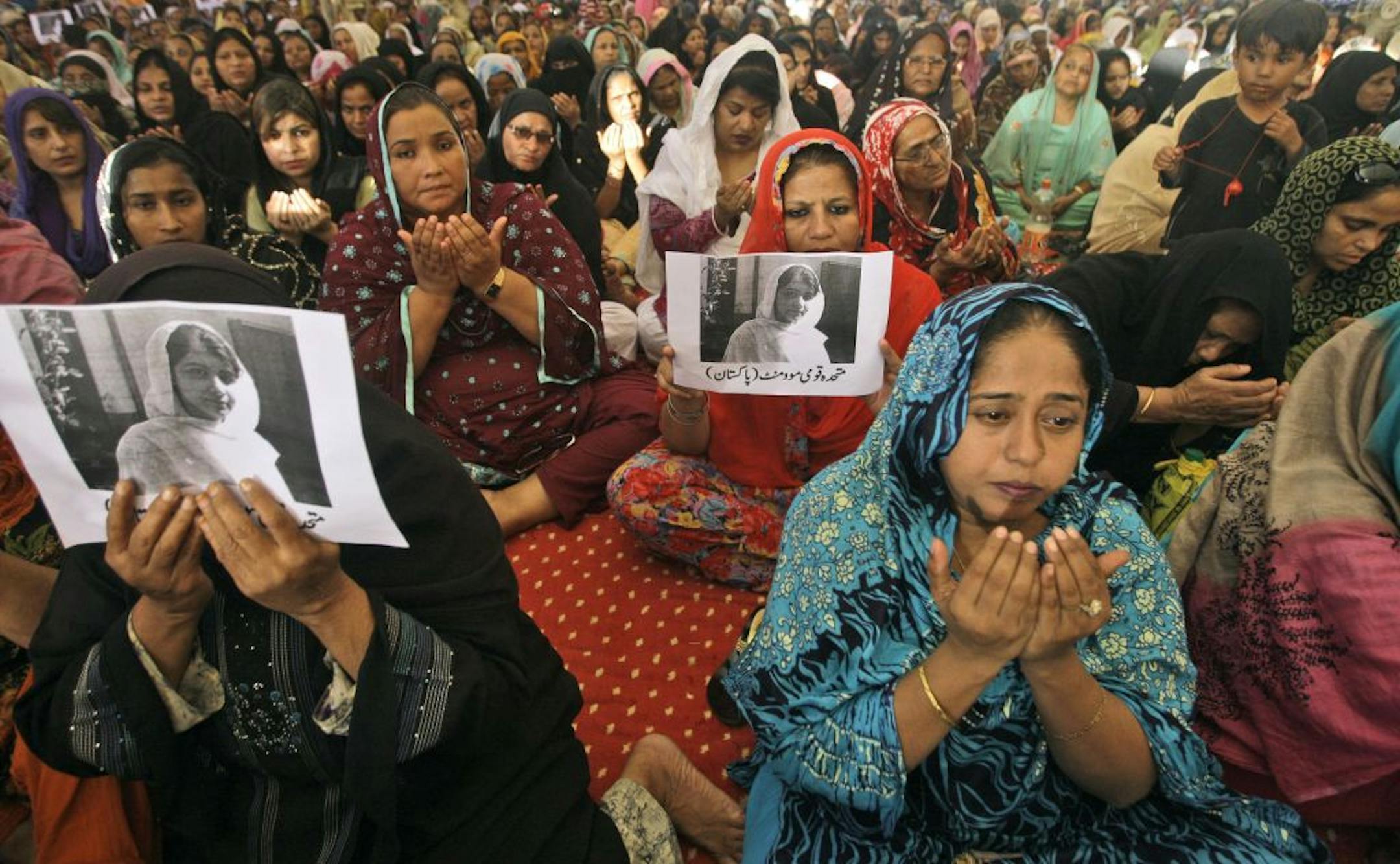Supporters of Pakistani political party Muttahida Qaumi Movement (MQM), chant prayers in support of 14-year-old schoolgirl Malala Yousufzai, who was shot on Tuesday by the Taliban for speaking out in support of education for women, at the (MQM)' headquarter in Karachi, Pakistan, Wednesday, Oct. 10, 2012. Pakistani doctors successfully removed a bullet Wednesday from the neck of a 14-year-old girl who was shot by the Taliban for speaking out in support of education for women, a government ministe