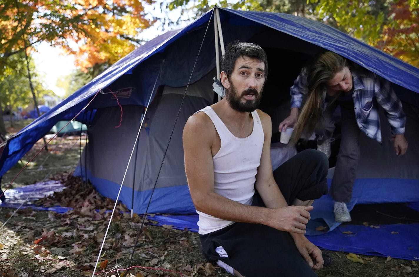 Brandon Harrison, 35, celebrated his birthday at a homeless encampment in Logan Park with his girlfriend Nichol Wyandt , 43, Wednesday in Minneapolis. Harrison, who has dealt with opioid addiction for the past six years is in recovery and credits his addiction for humbling him. "I'm rediscovering my self worth," said Harrison, outside the tent he shares with Wyandt.] DAVID JOLES • david.joles@startribune.com Standalone feature photo Wednesday, Oct. 7, 2020, in Minneapolis, MN The remaining encam