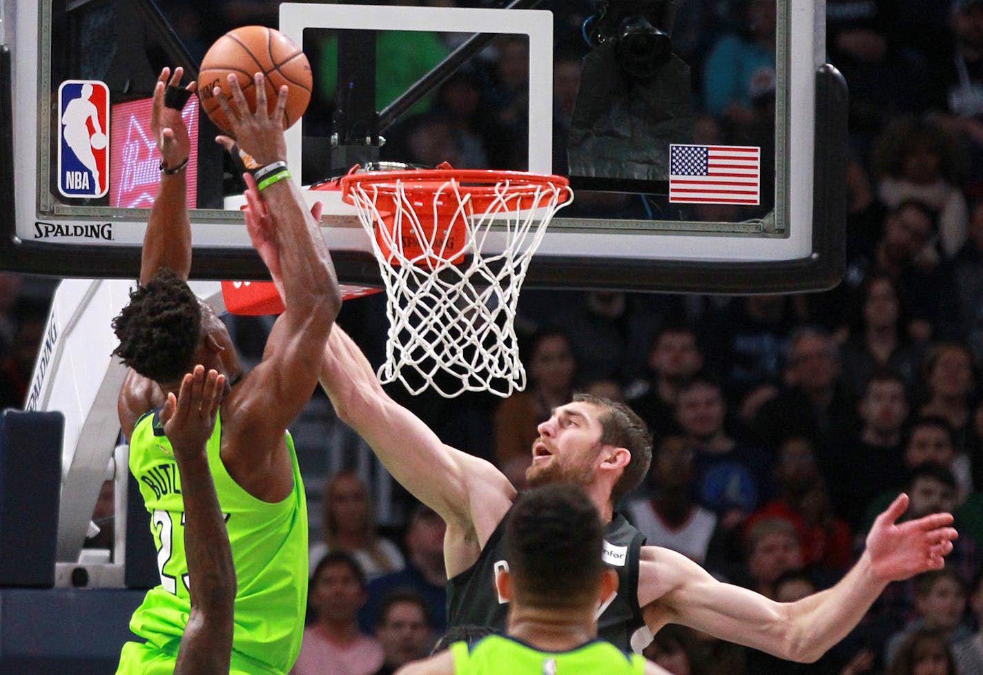 Brooklyn Nets center Tyler Zeller (44) fouls Minnesota Timberwolves guard Jimmy Butler (23) in the first quarter of an NBA basketball game Saturday, Jan. 27, 2018, in Minneapolis. (AP Photo/Andy Clayton-King)