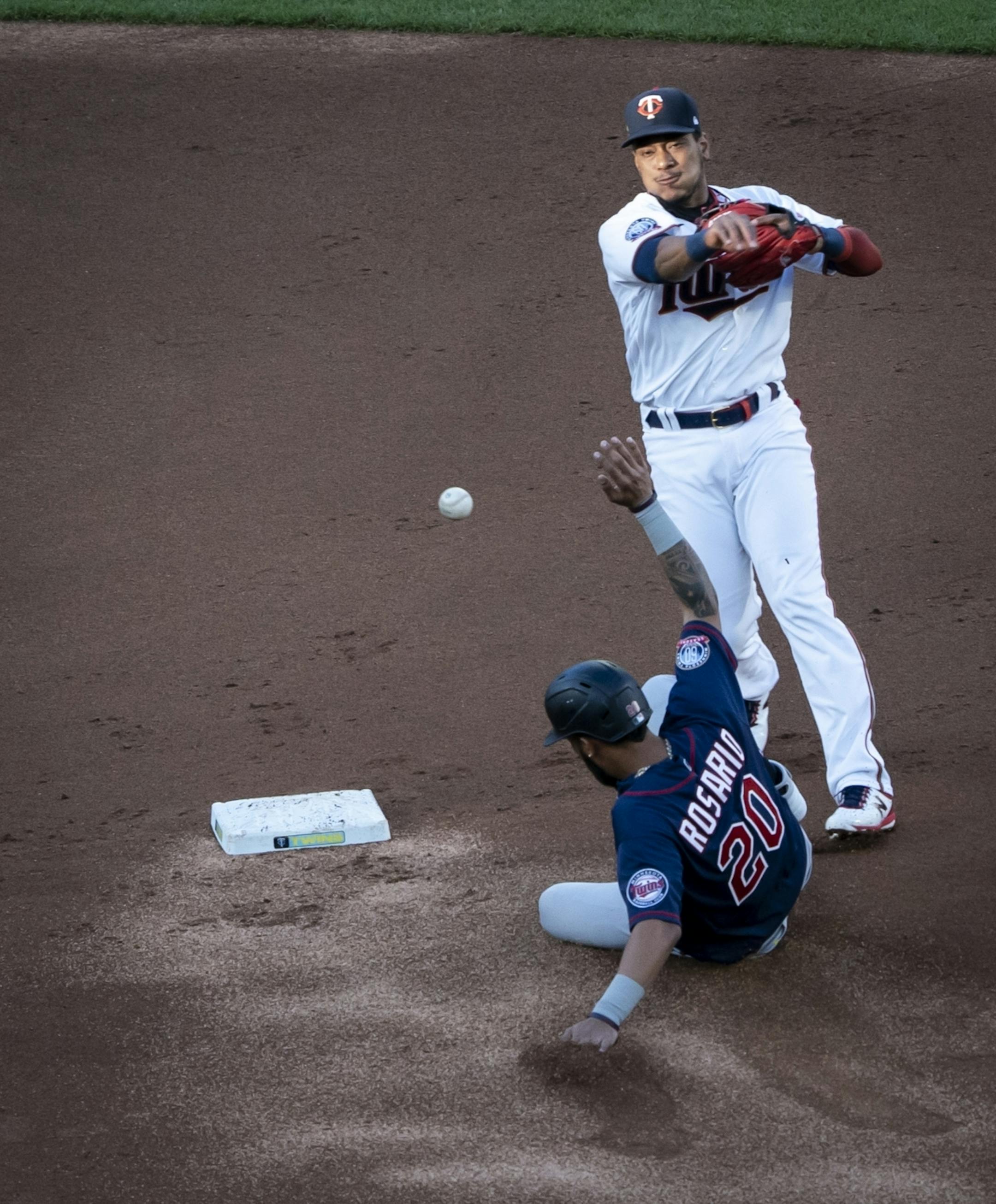 Minnesota Twins shortstop Jorge Polanco (11) threw to first for a double play including getting Minnesota Twins right fielder Eddie Rosario (20) at second in the first inning of a scrimmage at practice at Target Field in Minneapolis, Minn., on Wednesday, July 15, 2020.