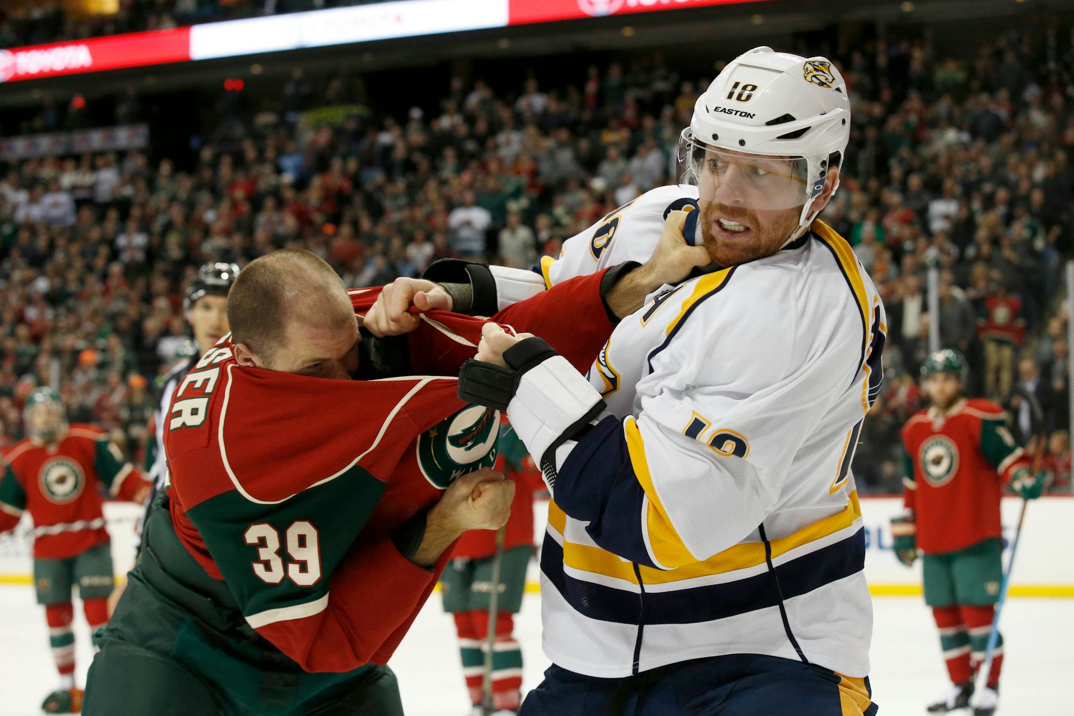 Nashville Predators left wing James Neal (18) and Minnesota Wild defenseman Nate Prosser (39) fight during the second period of an NHL hockey game in St. Paul, Minn., Saturday, Nov. 21, 2015. (AP Photo/Ann Heisenfelt)