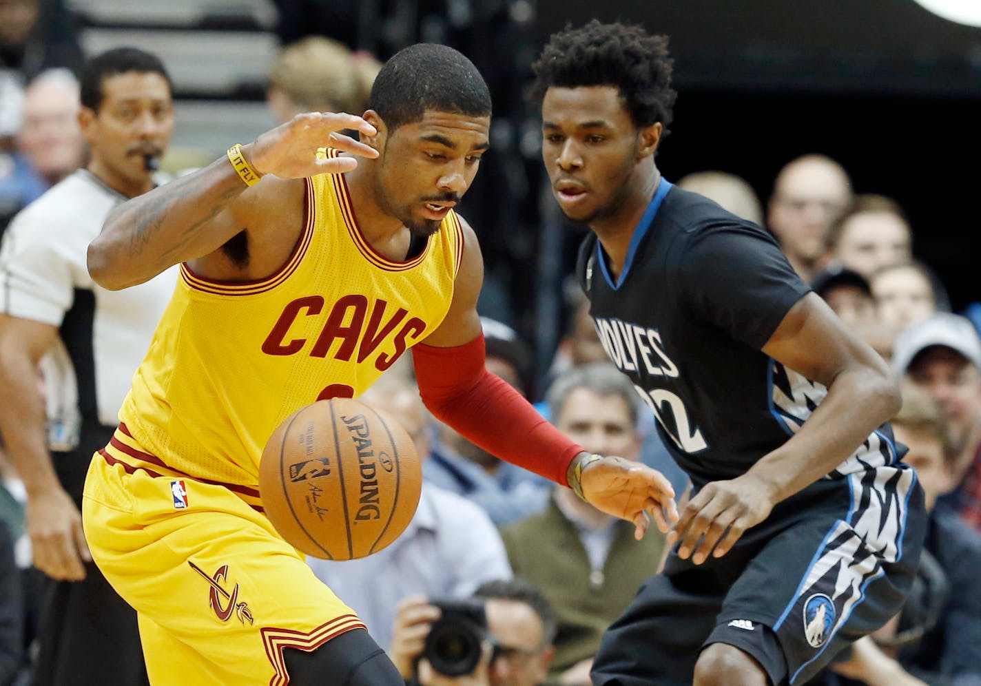 Kyrie Irving, left, watches the ball with Andrew Wiggins in the first quarter of an NBA basketball game, Friday, Jan. 8, 2016, in Minneapolis. (AP Photo/Jim Mone)