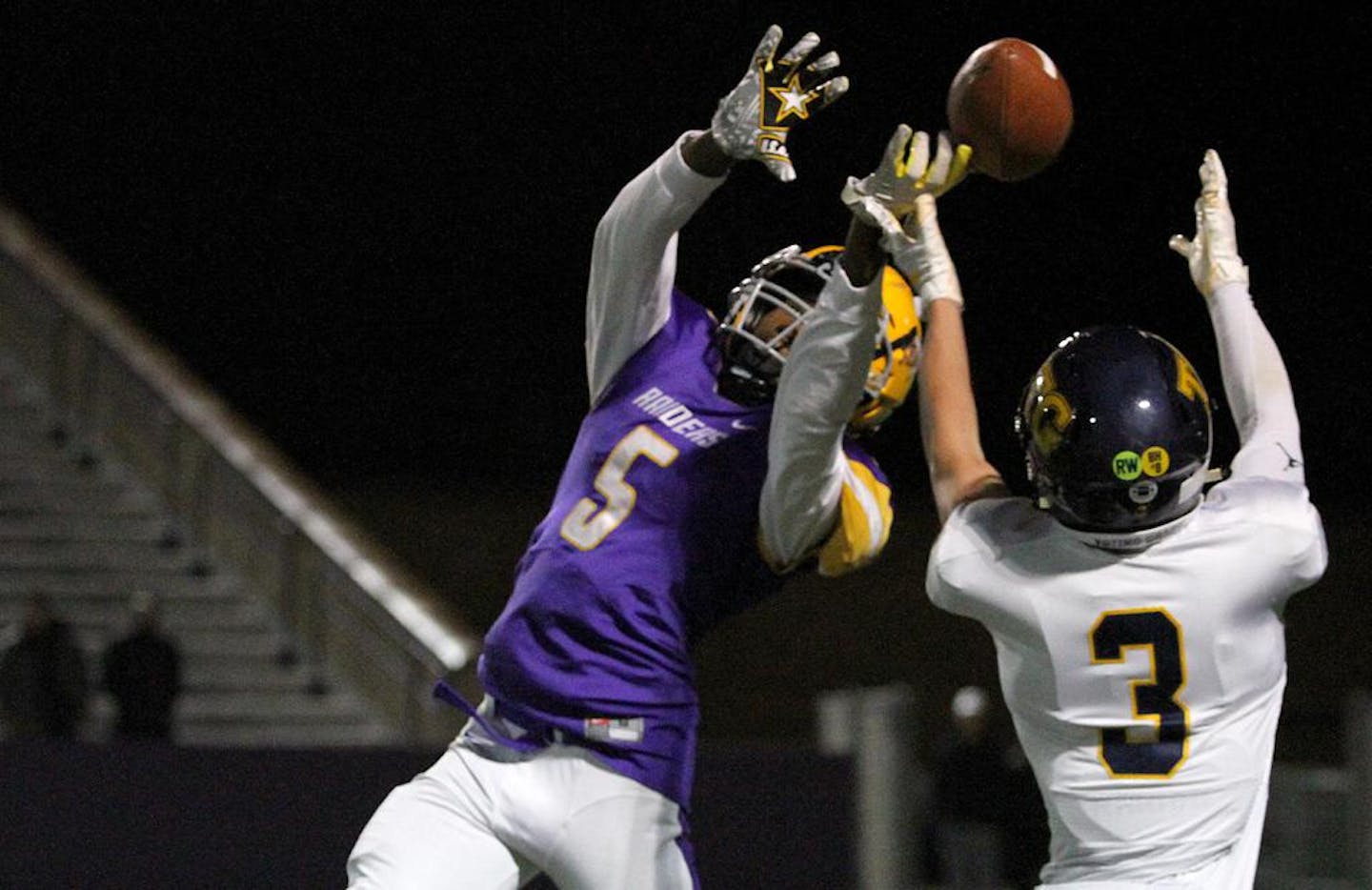 Cretin-Derham Hall defensive back Tre Holloman (5) makes a play on the ball during a 2019 game against Totino-Grace. Photo by Drew Herron, SportsEngine