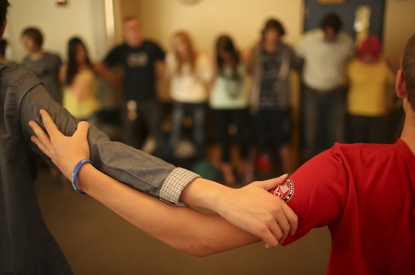 At the conclusion of the daily check-in at PEASE Academy Thursday morning, May 16, 2013, everyone joined hands or arms and recited the Serenity Prayer before going on with the rest of the school day.