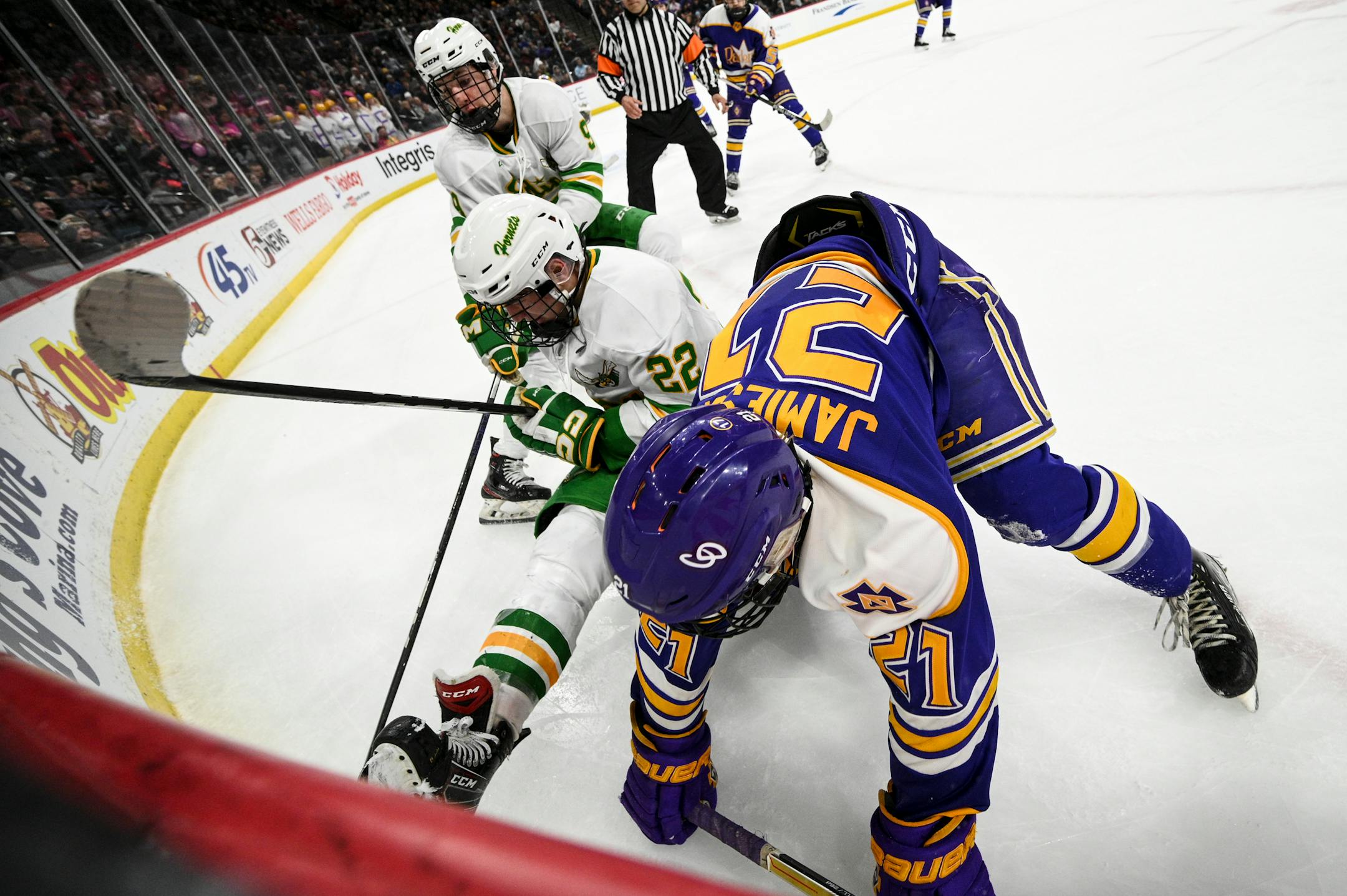 Cretin-Derham Hall defenseman Luke Chorlton (27) and Edina forward John Warpinski (22) battle for the puck during the second period.
