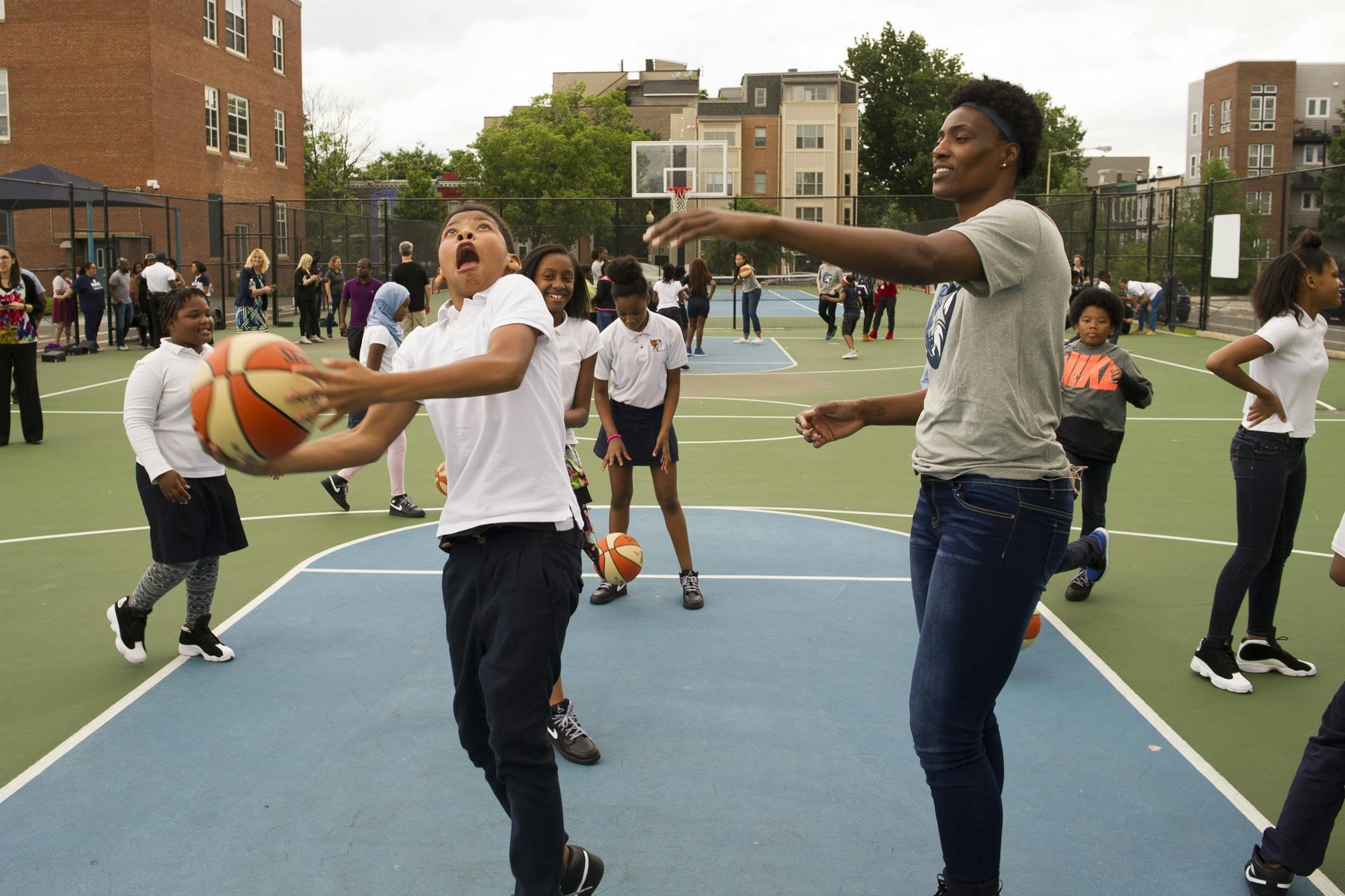 WNBA Champion Minnesota Lynx' Lynetta Kizer watches a student do a layup at Payne Elementary School in Washington, Wednesday, June 6, 2018. Payne Elementary has the highest homeless student population in Washington.