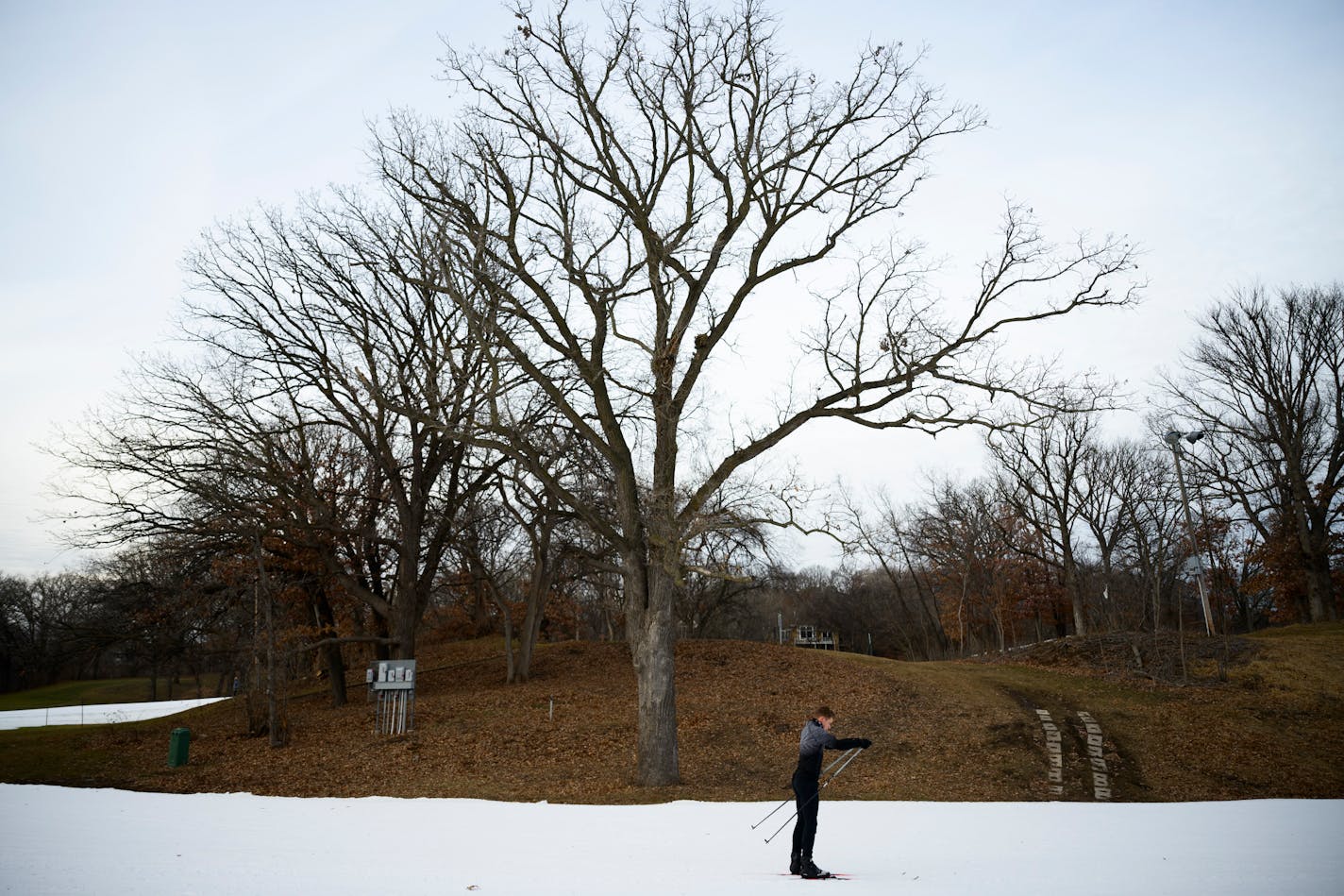 A nNrdic skier makes their way around a loop made of artificial snow Tuesday, Dec. 19, 2023 at Theodore Wirth Park in Minneapolis, Minn.. ] AARON LAVINSKY • aaron.lavinsky@startribune.com