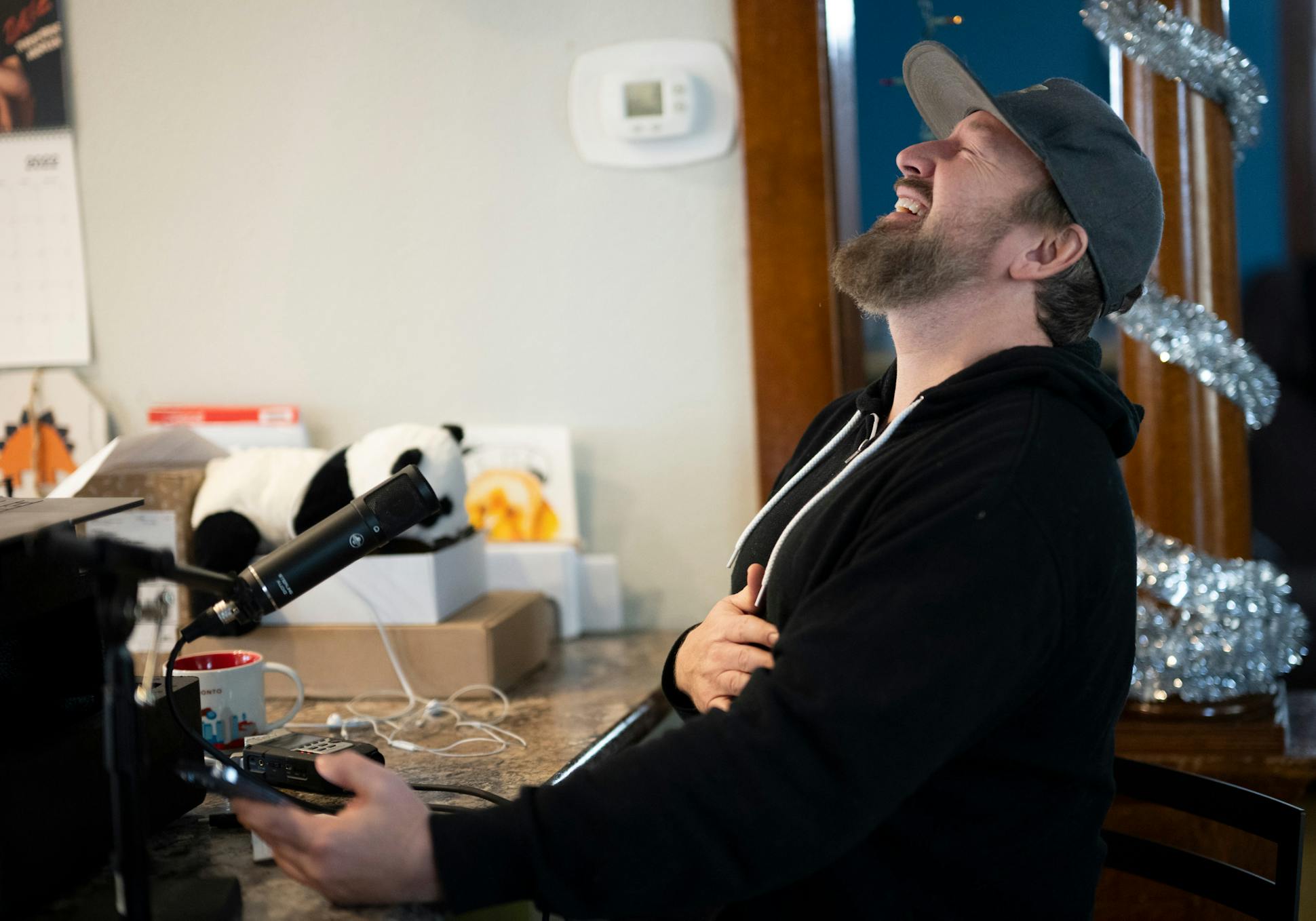 Chad Daniels belted out a laugh while speaking to co-host Cy Amundson after recording an episode of their podcast, “The Middle of Somewhere” in his home.