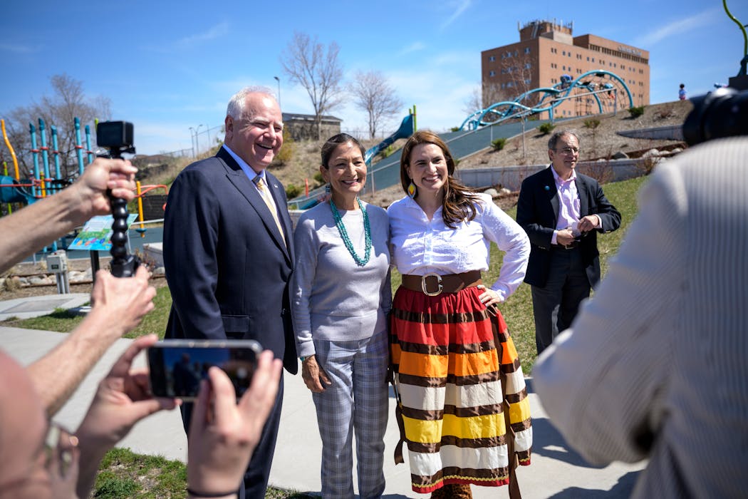 Interior Secretary Deb Haaland posed for a photo alongside Minnesota Gov. Tim Walz and Lt. Gov. Peggy Flanagan after a press conference in May at Midway Peace Park in St. Paul. Flanagan was wearing her “fire earrings” made by designer Charlie Stately, who owns Woodland Indian Craft in Minneapolis, and a ribbon skirt from Minnesota-based Beads Sews Creations.
