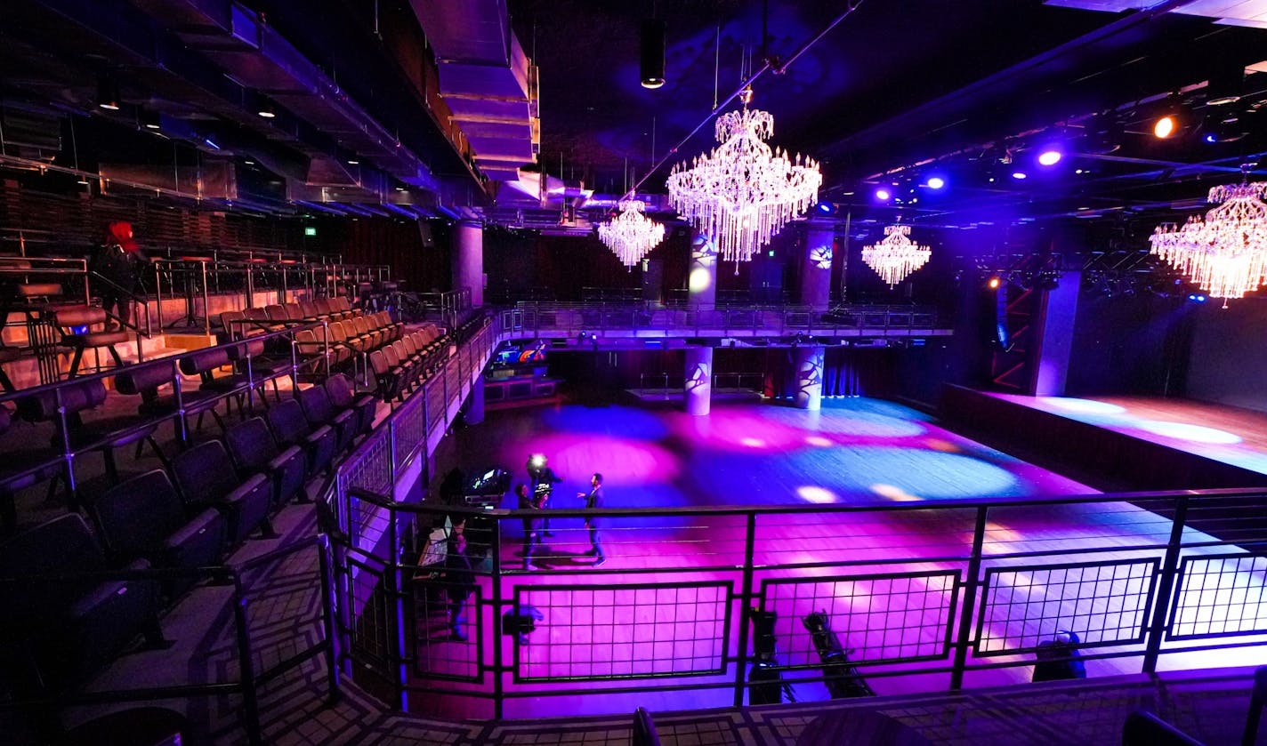 Chandeliers hang above the main floor of the Fillmore Minneapolis, viewed from the tiered balcony seats.