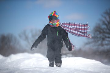 A boy looked on during a snowball fight between the cities of St. Paul and Minneapolis on a gusty day in 2019.