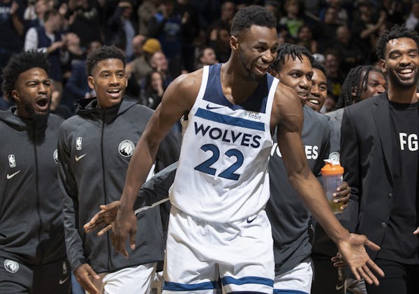 Minnesota Timberwolves Andrew Wiggins (22) was greeted by teammates on the court after making his third three pointer late in the fourth quarter.