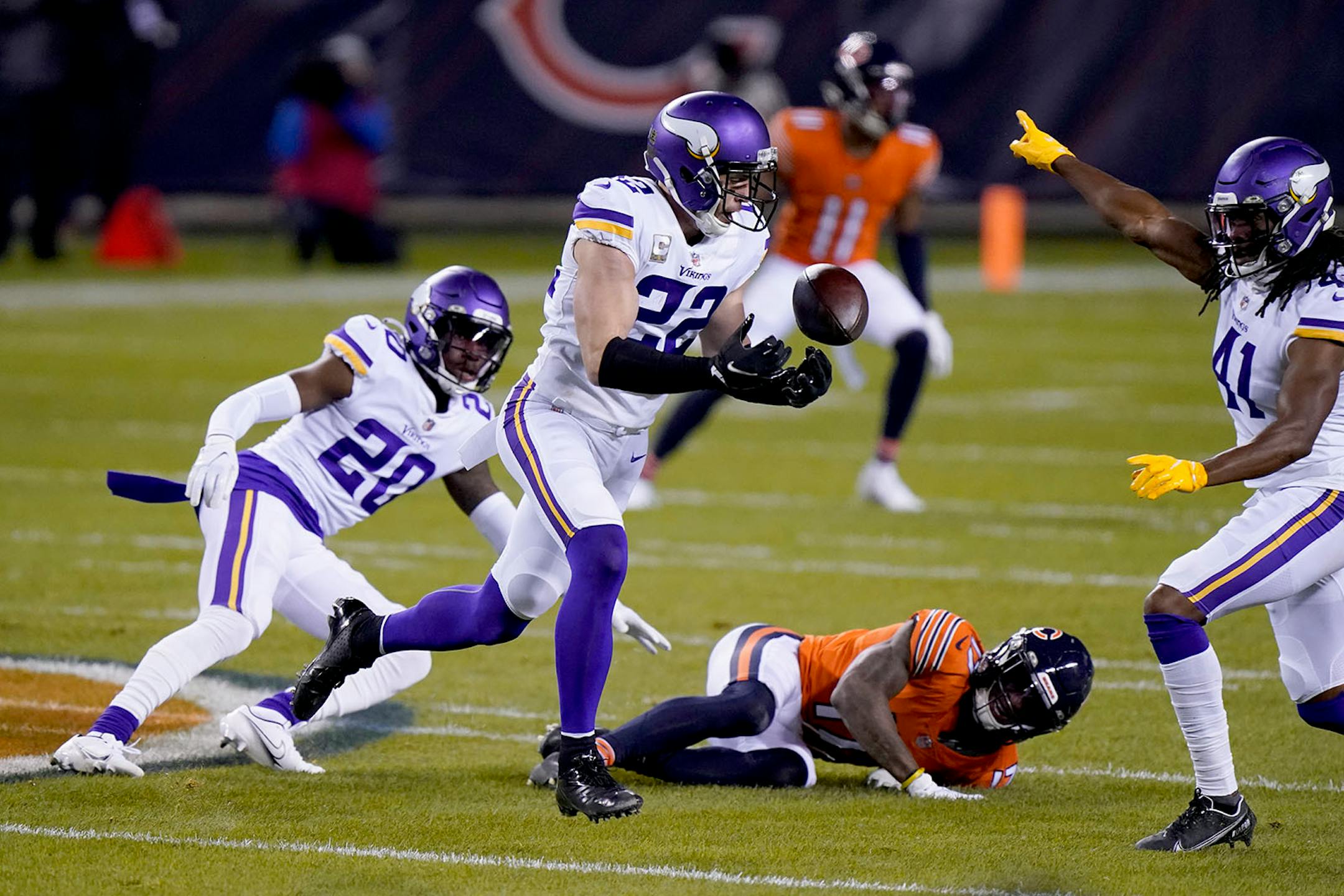 Minnesota Vikings safety Harrison Smith (22) intercepts a pass as teammates cornerback Jeff Gladney (20) and safety Anthony Harris (41) watch along with Chicago Bears wide receiver Anthony Miller (17) during the first half of an NFL football game Monday, Nov. 16, 2020, in Chicago. (AP Photo/Nam Y. Huh)