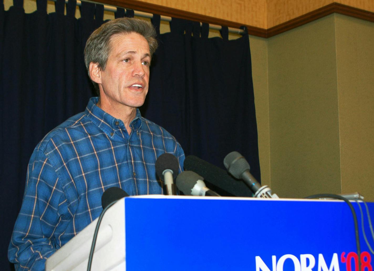 Sen. Norm Coleman speaks at a news conference in Moorhead, Minn. He said allegations in a lawsuit that a friend and donor funneled $75,000 to an insurance company that employs his wife are "false and defamatory."