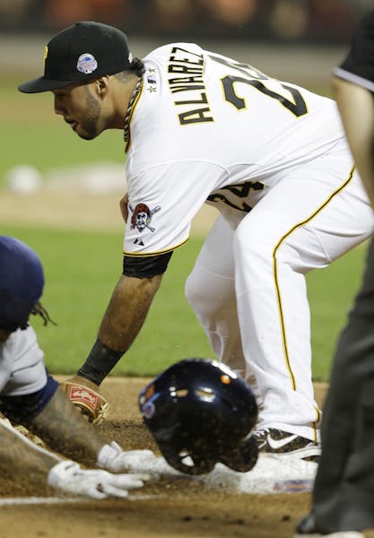 American League&#xed;s Prince Fielder, of the Detroit Tigers, is safe at third as National League&#xed;s Pedro Alvarez, of the Pittsburgh Pirates, att