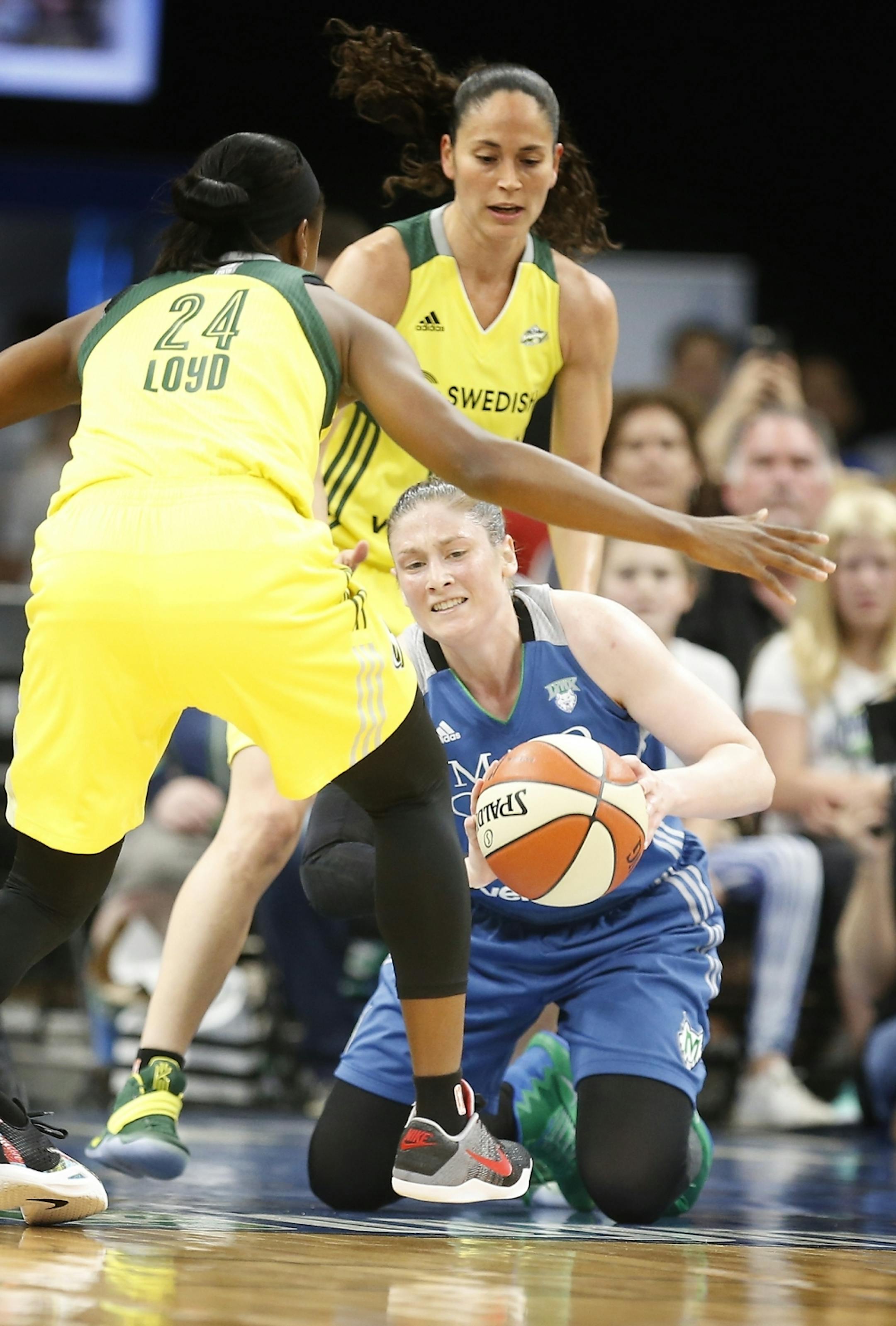Minnesota Lynx guard Lindsay Whalen (13) looks to pass the ball on the ground during the first half.