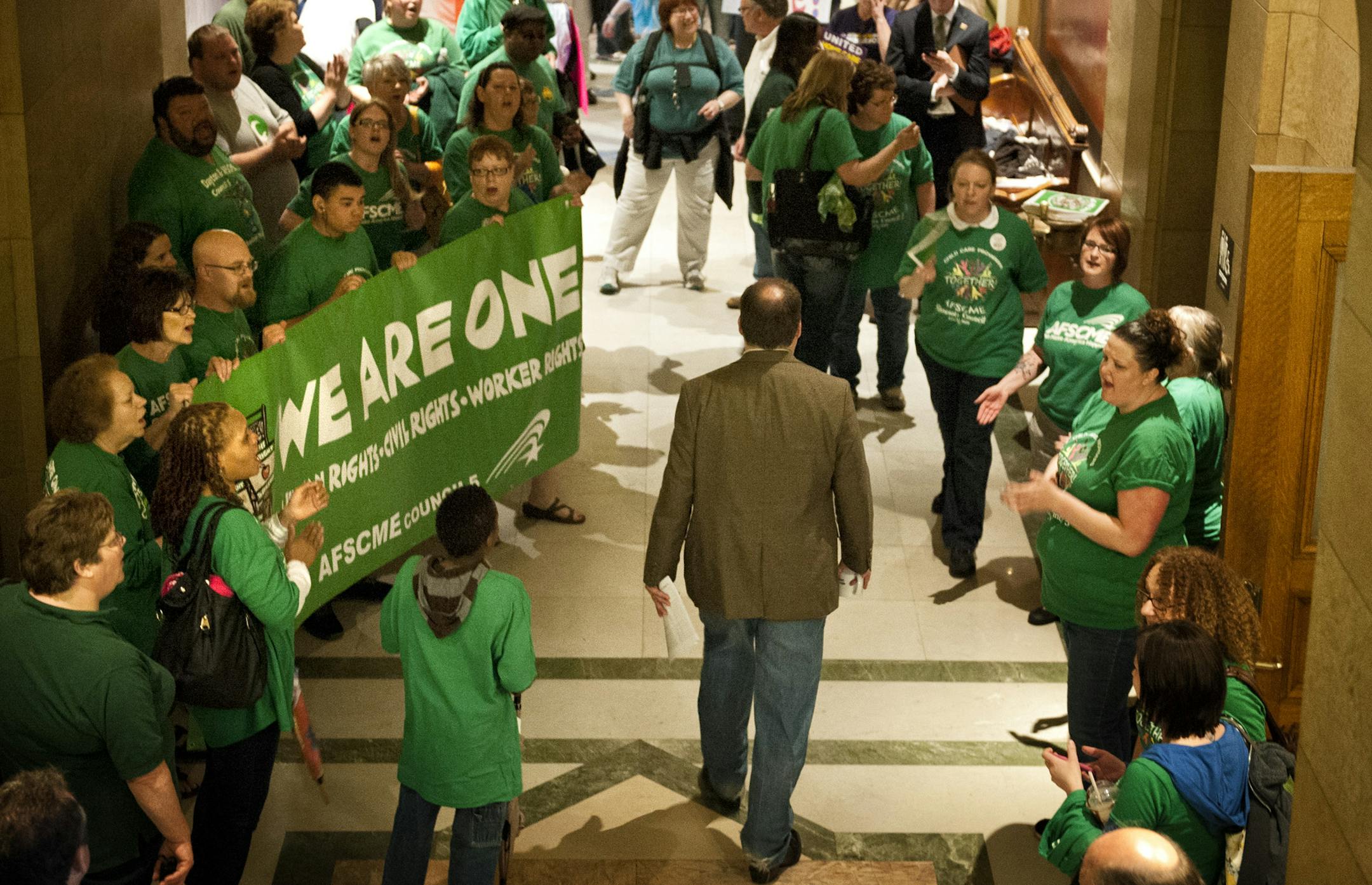 Assistant Minority Leader Kelby Woodard, R-Belle Plaine walked through the gauntlet of cheering advocates for both sides of the daycare unionization demonstrators. Vote Yes and Vote No echoed in throughout the Capitol Saturday, May 18, 2013 as legislators were set to debate the childcare unionization bill. ] GLEN STUBBE * gstubbe@startribune.com