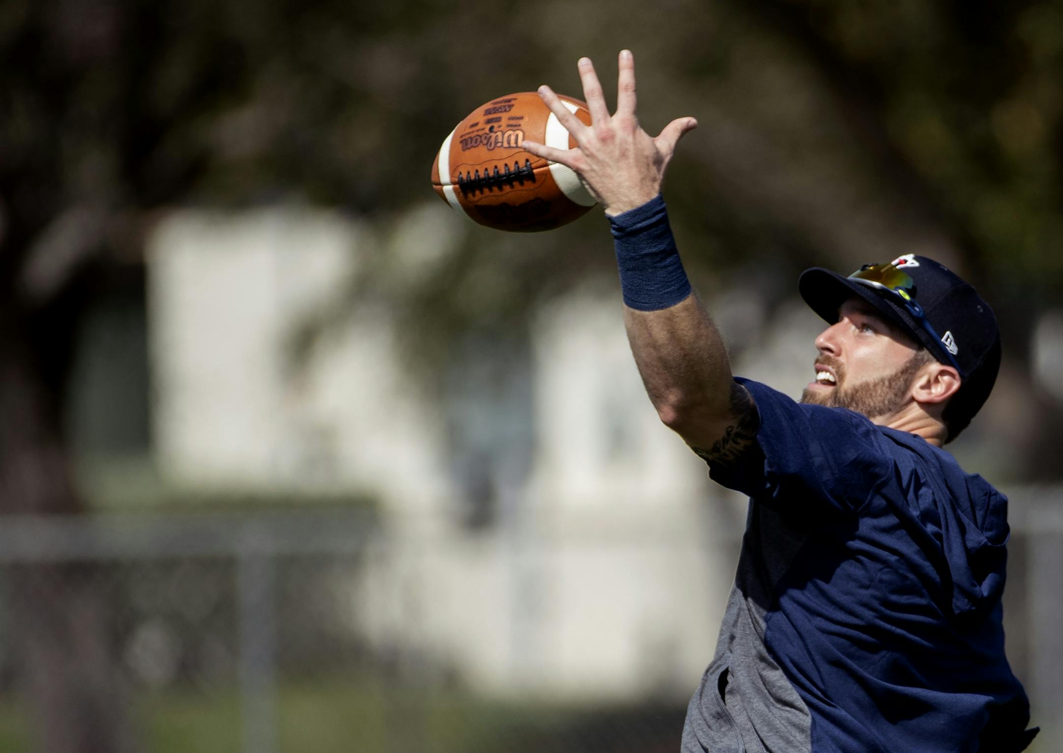 Minnesota Twins Jack Reinheimer made a one handed catch of a football during practice on Tuesday.