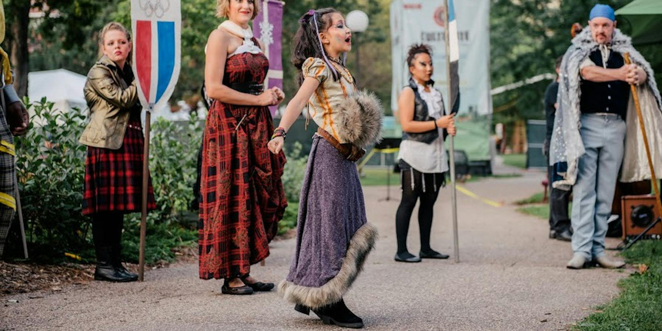Photo credit: Marie Ketring: Pictured from left to right: Josie Ross, Maggie Lofboom, Taylor Her, JP Fitzgibbon, and Natalie Tran is in the center with the purple skirt. All eyes are on Lady Steeger Bancroft, an explorer, played by Natalie Tran, in this scene of Mixed Precipitation's production of "King Arthur," which includes an all-ages cast. Punk rock meets baroque music in the garden for this unique retelling of the old English language opera.