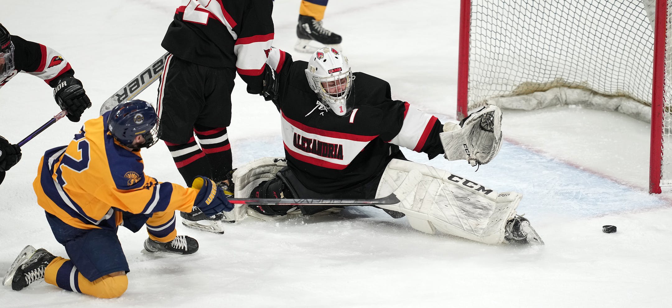 Mahtomedi forward Carter Haycraft (22) shoots wide of Alexandria goaltender Elijah Rasmusen (1) in the second period of a MSHSL Class 1A quarterfinal hockey game between Alexandria and Mahtomedi.