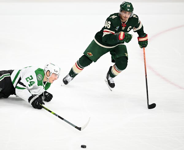 Dallas Stars center Roope Hintz (24) loses control of the puck as he's pursued by Minnesota Wild defenseman Jared Spurgeon (46) during the second peri