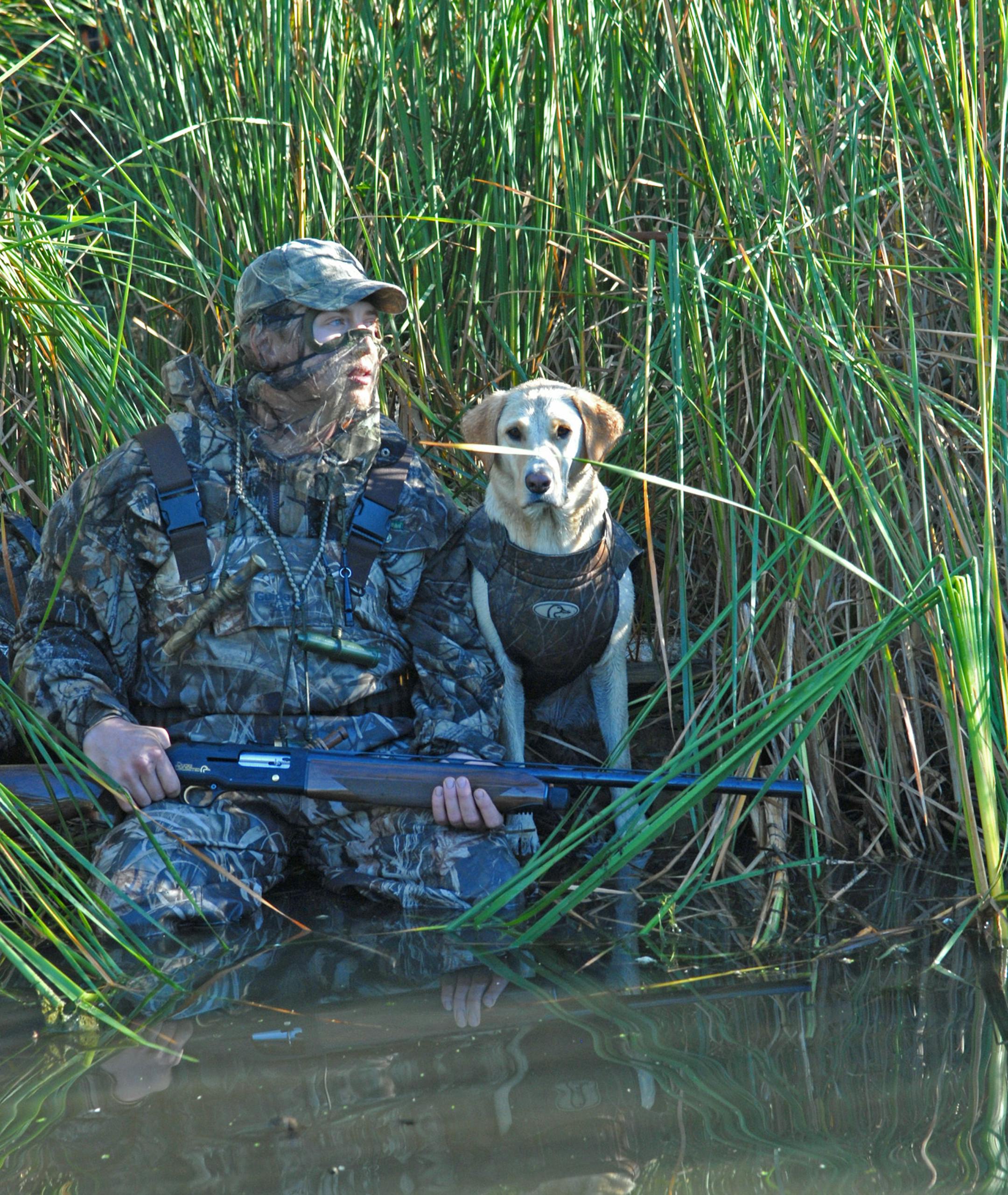 Neil Smith of Babbitt, Minn., and his yellow Labrador Jade conceal themselves, hoping for a shot at a passing duck Saturday morning.