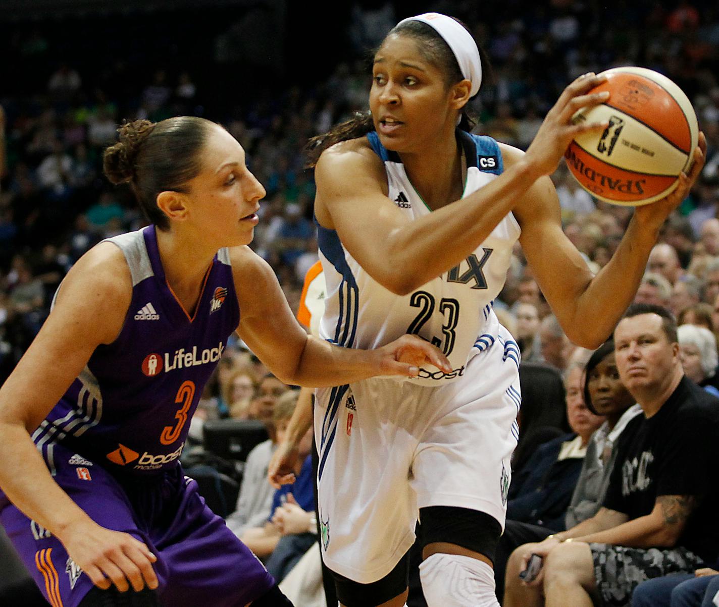 Minnesota Lynx forward Maya Moore (23) looks to pass against Phoenix Mercury guard Diana Taurasi (3) during Game 1 of the WNBA basketball playoffs Western Conference finals on Thursday, Sept. 26, 2013, in Minneapolis. (AP Photo/Stacy Bengs)