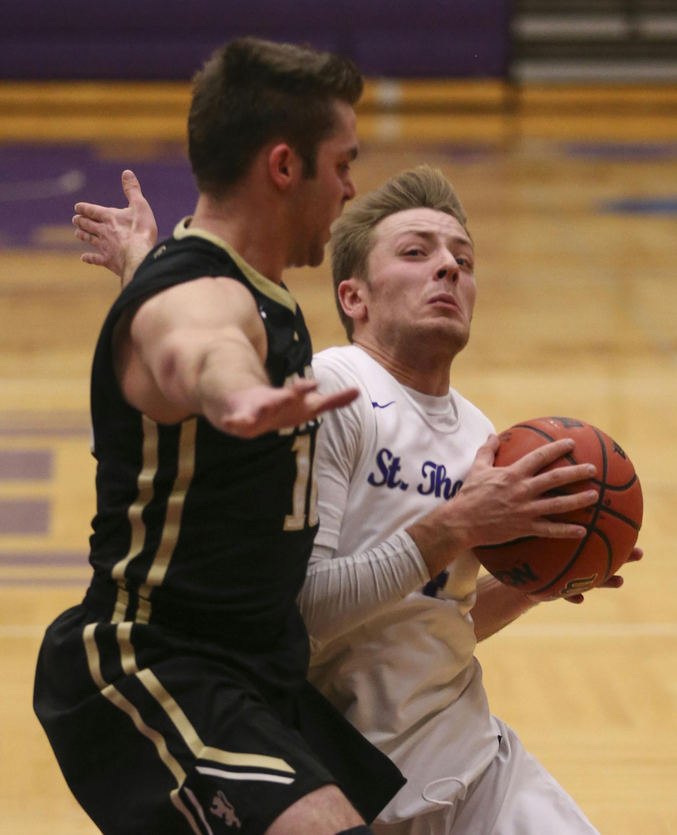The Tommies' Grant Shaeffer drove around the Oles' Evan O'Dorisio in the first half Wednesday night. ] JEFF WHEELER ï jeff.wheeler@startribune.com Grant Shaeffer was two-time state champion at quarterback for Eden Prairie. Now he is a junior point guard for the University of St. Thomas basketball team. The Tommies hosted St. Olaf Wednesday night, January 20, 2016 in St. Paul.