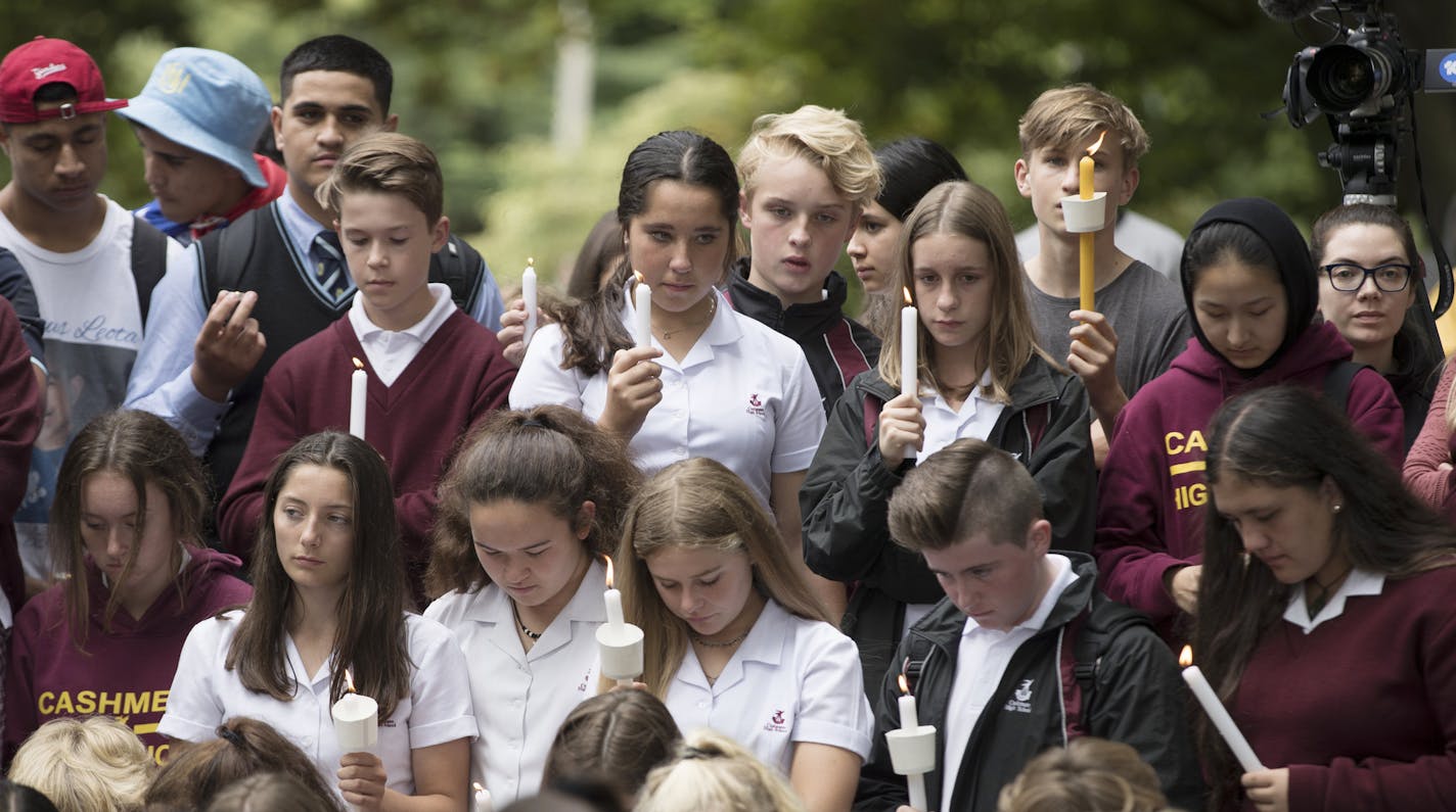 Students hold candles during a moment of silence as they gather for a vigil to commemorate victims of Friday's shooting, outside the Al Noor mosque in Christchurch, New Zealand, Monday, March 18, 2019. Three days after Friday's attack, New Zealand's deadliest shooting in modern history, relatives were anxiously waiting for word on when they can bury their loved ones. (AP Photo/Vincent Thian)