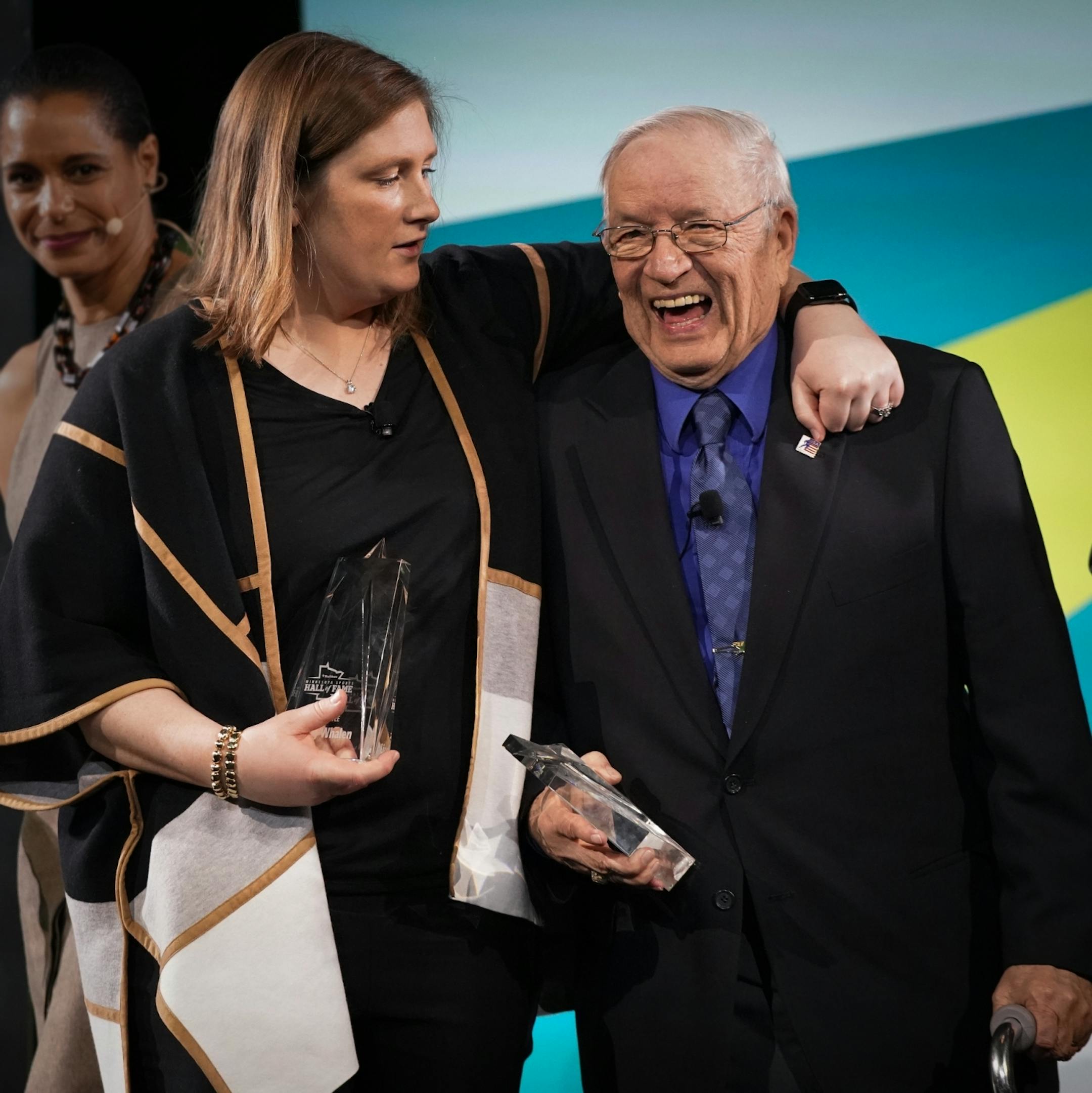 Lindsay Whalen put her arm around Willard Ikola as she made him laugh after both were inducted into the Star Tribune Sports Hall of Fame.