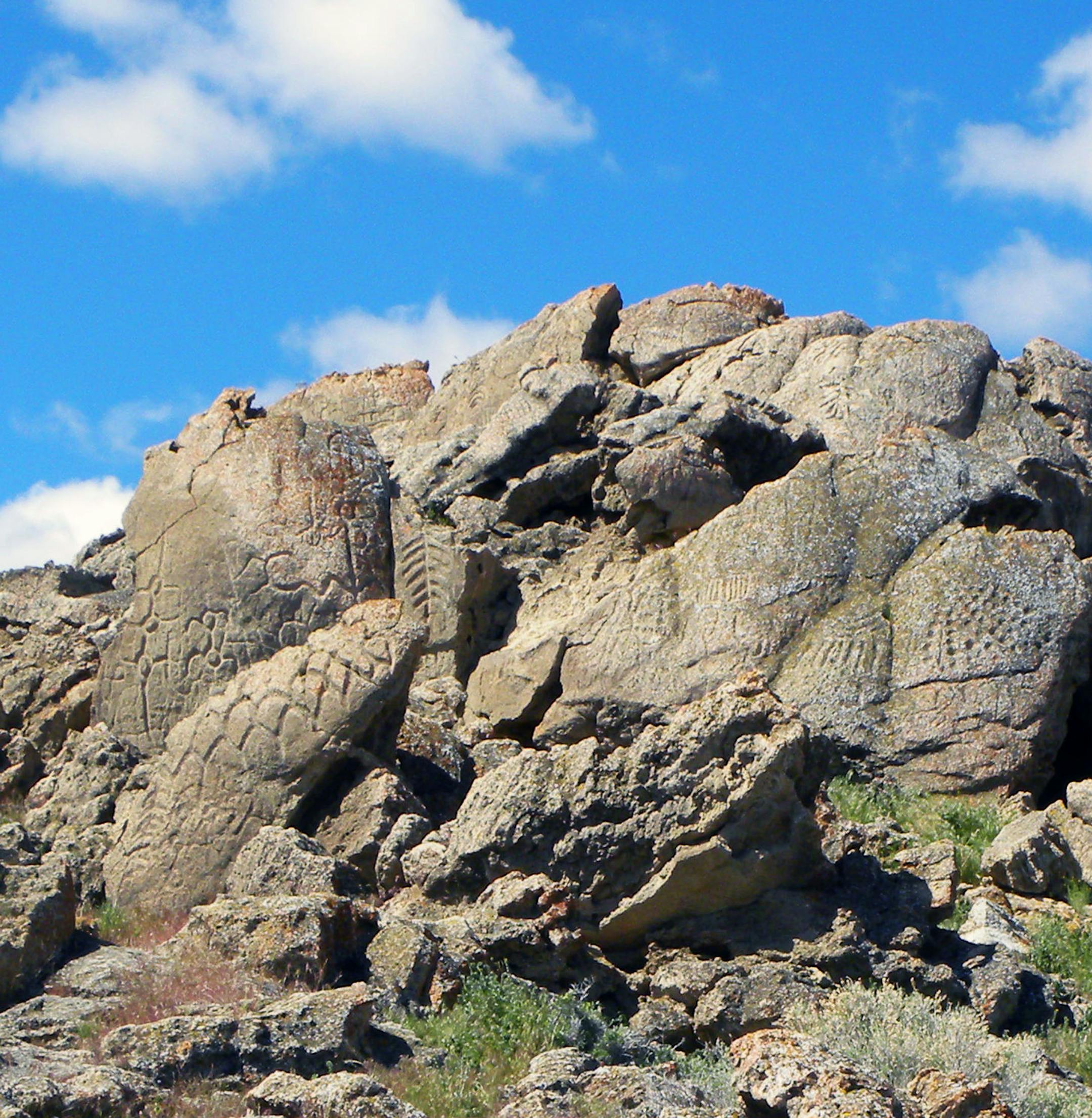 This May 2012 photo provided by the Nevada State Museum shows ancient carvings on limestone boulders near Nevada's Pyramid Lake which have been confirmed to be the oldest recorded petroglyphs in North America - at least 10,500 years old. Larry Benson, the curator of anthropology at the University of Colorado Natural History Museum, and Eugene Hattori, curator of anthropology at the Nevada State Museum, were among the co-authors of a paper on the findings in August 2013 in the Journal of Archaeol