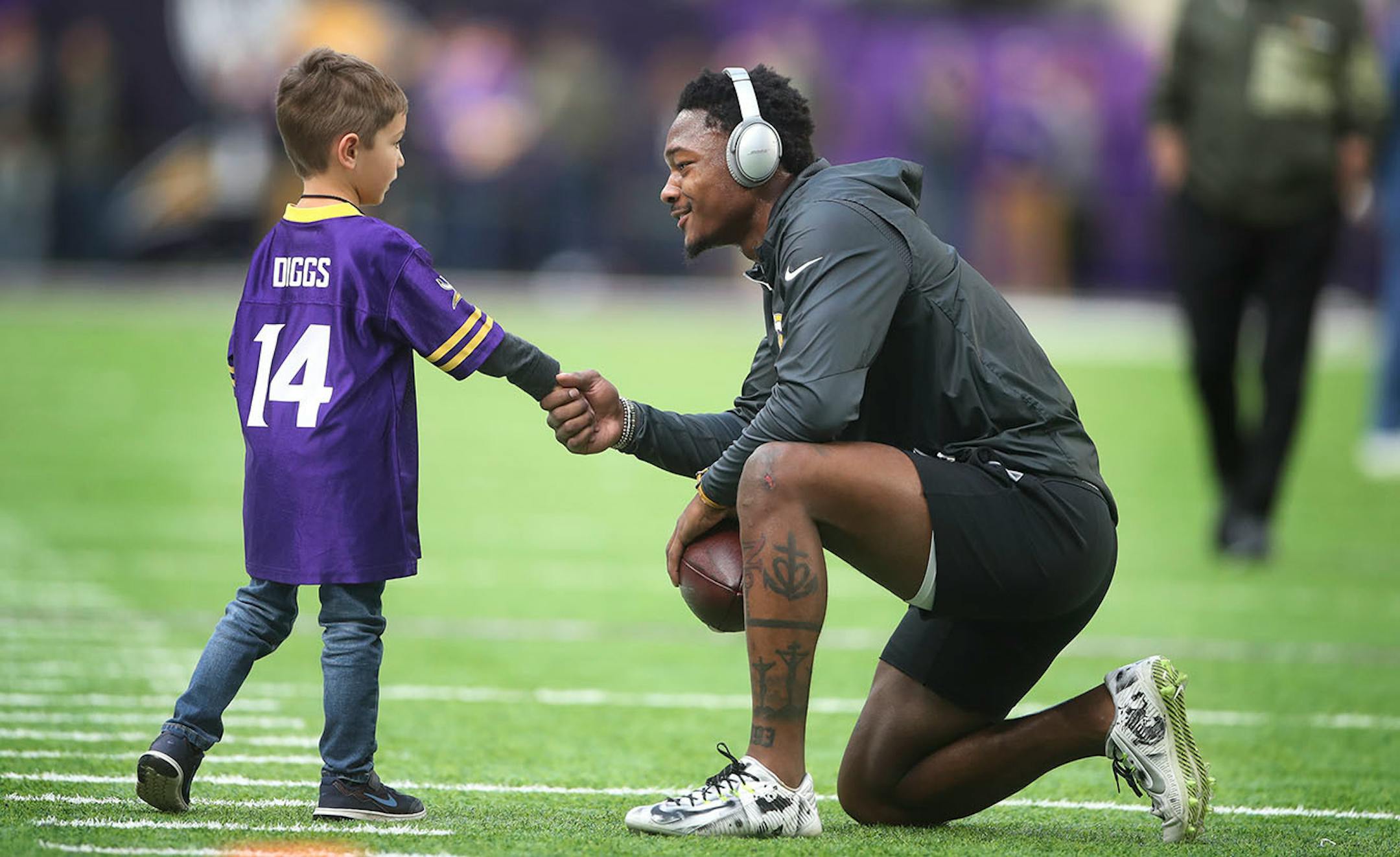 Minnesota Vikings wide receiver Stefon Diggs (14) shook hands with Wyatt Ficken 5, of Eden Prairie during warmups at U.S. Bank Stadium Sunday November 19, 2017 in Minneapolis, MN.